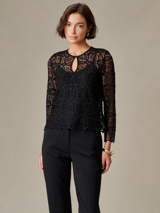 J.McLaughlin Whitmore Lace Blouse in black lace with long sleeves and keyhole neckline styled with black pants on a model