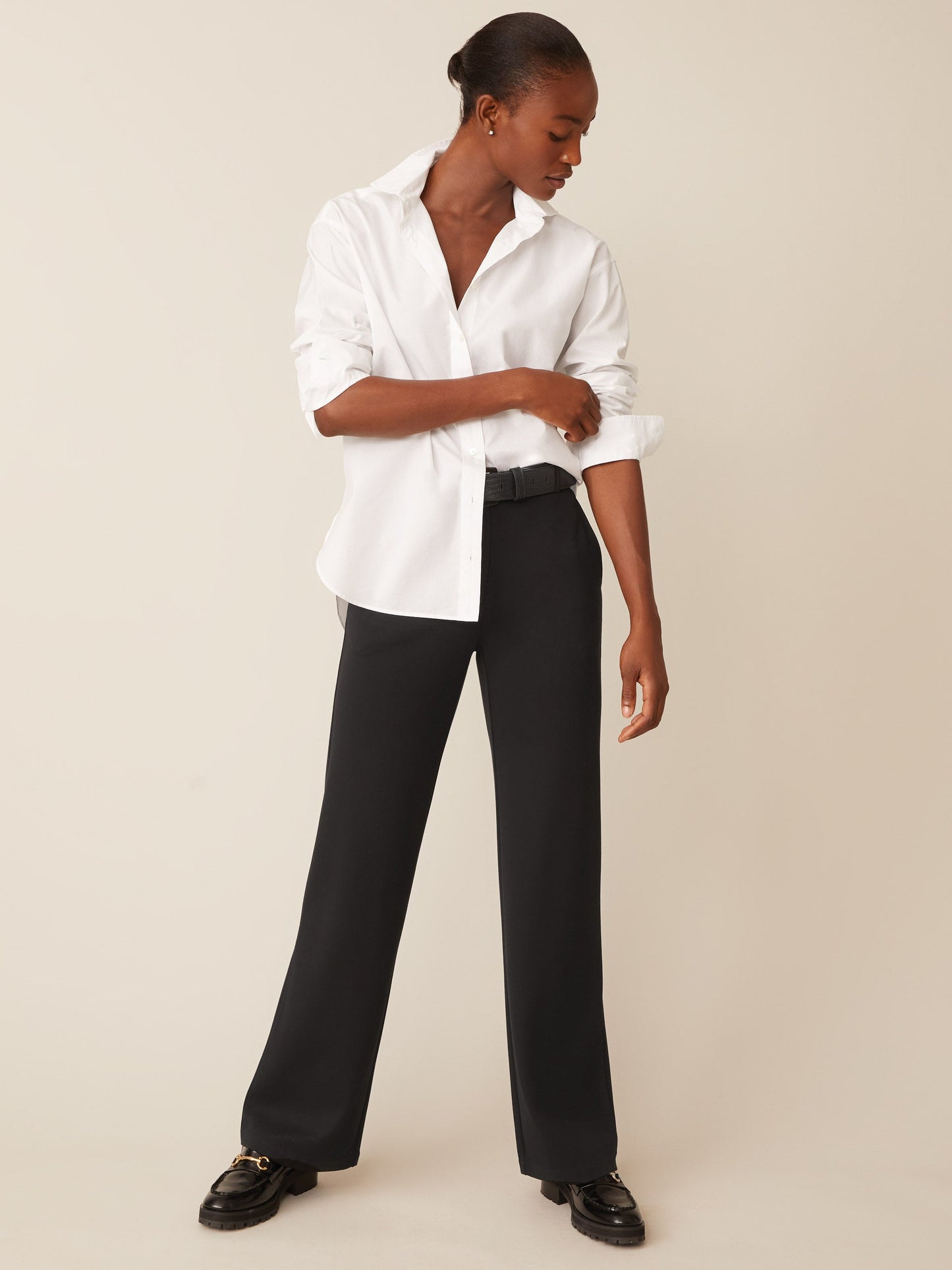 Model wearing J.McLaughlin Brock pants in black made with bainbridge fabric.