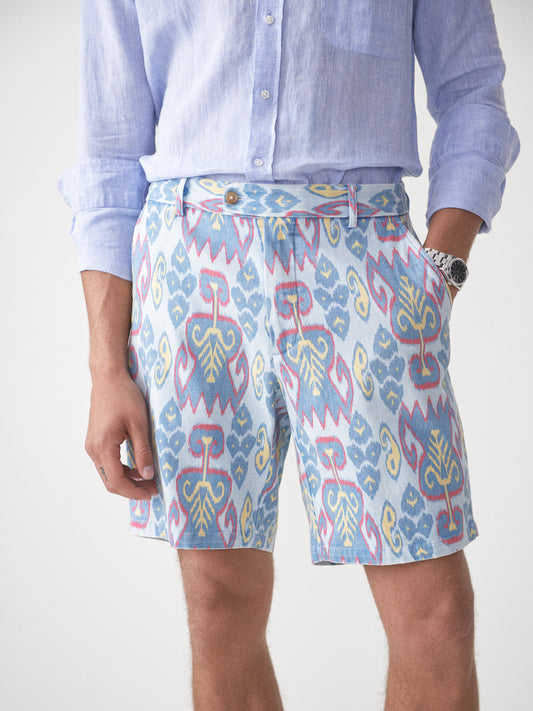 Model wearing J.McLaughlin Oliver shorts in aqua/blue/gold made with cotton.