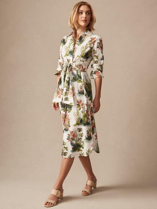 Woman wearing Orla Dress in Tidal Palms by J.McLaughlin featuring a botanical print with green and coral tones, styled with beige sandals, showcasing effortlessly stylish and enduring designs.