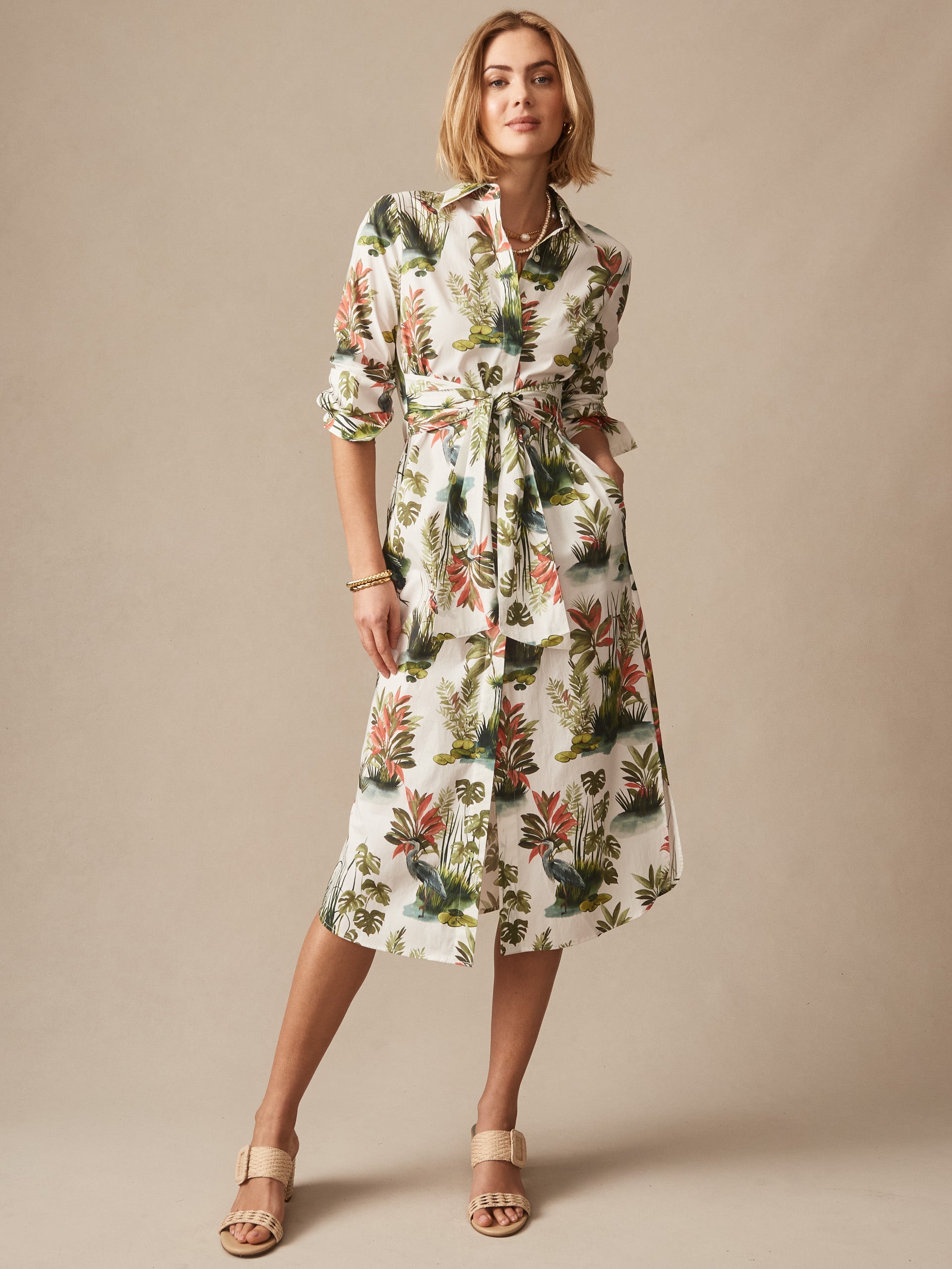 A model wearing the Orla Dress in Tidal Palms by J.McLaughlin, showcasing an effortlessly stylish floral print dress with a belted waist, reflecting enduring designs and classic craftsmanship.