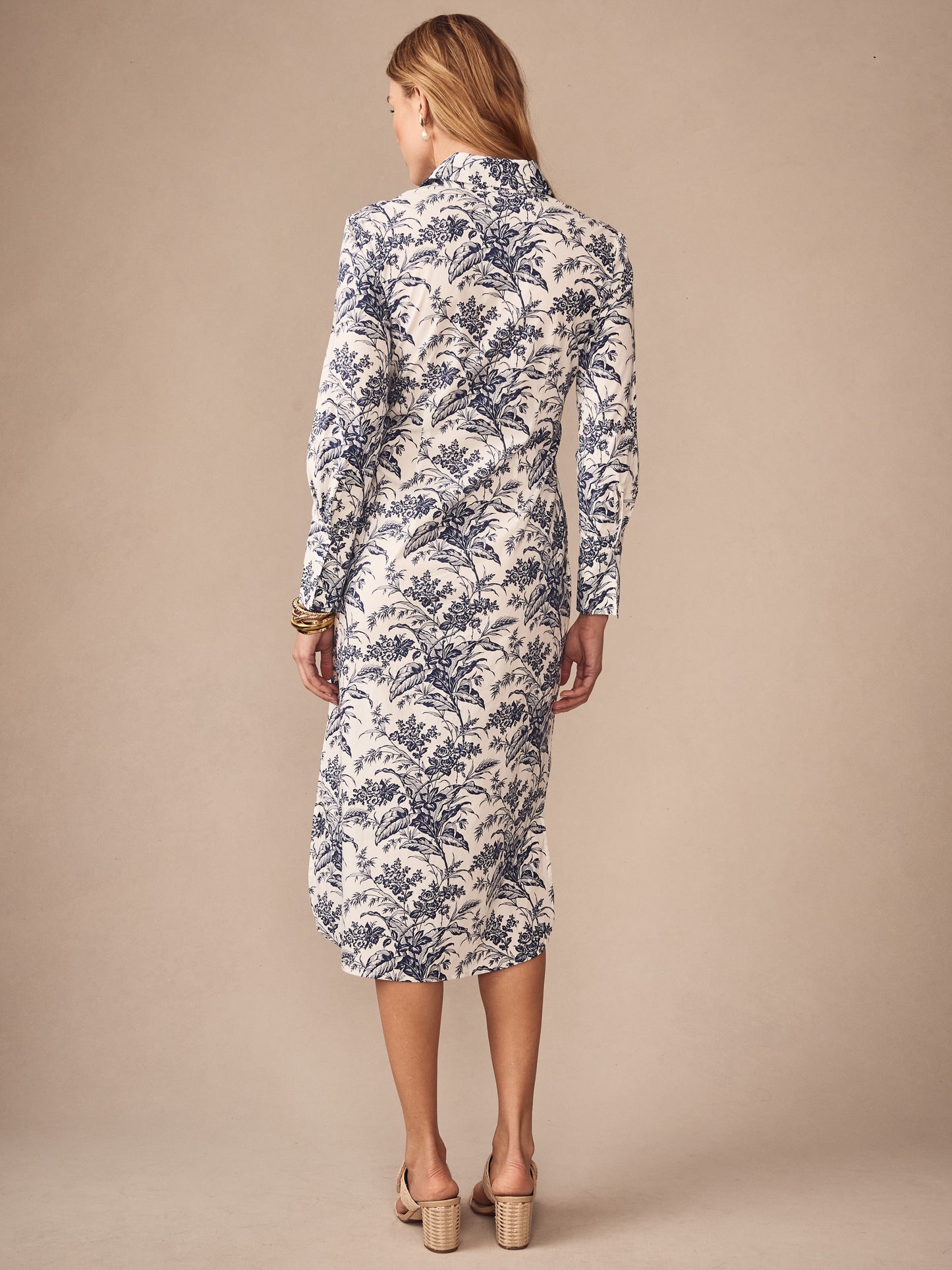 A woman models the Orla Dress in Giardino Toile by J.McLaughlin, showcasing an effortlessly stylish, enduring design with a classic floral pattern, embodying legacy of timeless fashion. A destination for defining style. Life, Well-Lived.