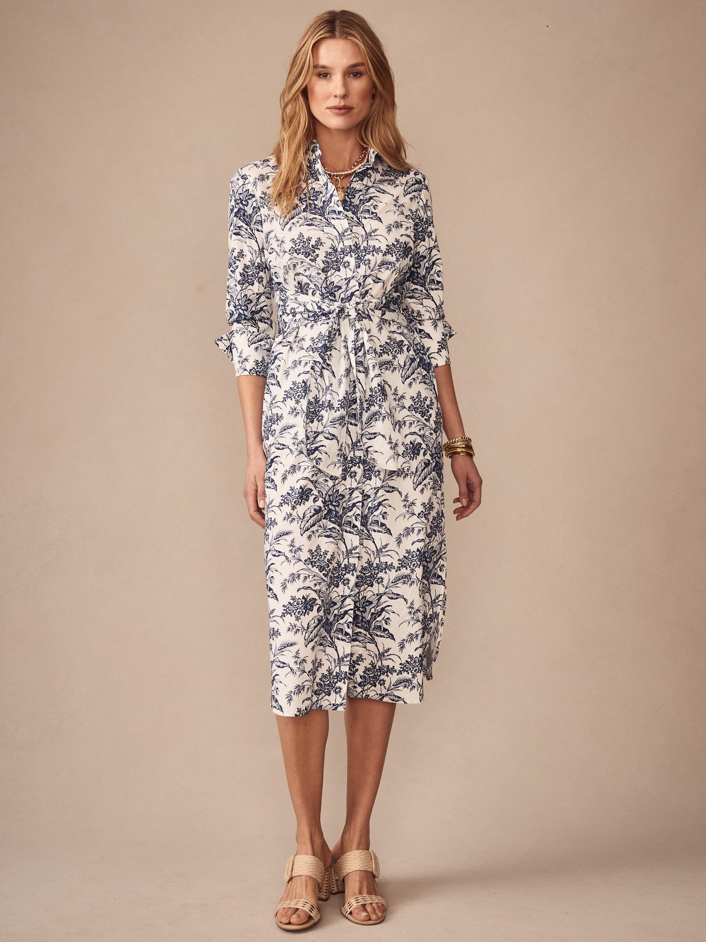 Woman wearing the Orla Dress in Giardino Toile by J.McLaughlin, featuring a classic navy and white print, effortlessly stylish with enduring designs and a legacy of timeless fashion. A destination for defining style. Life, Well-Lived.