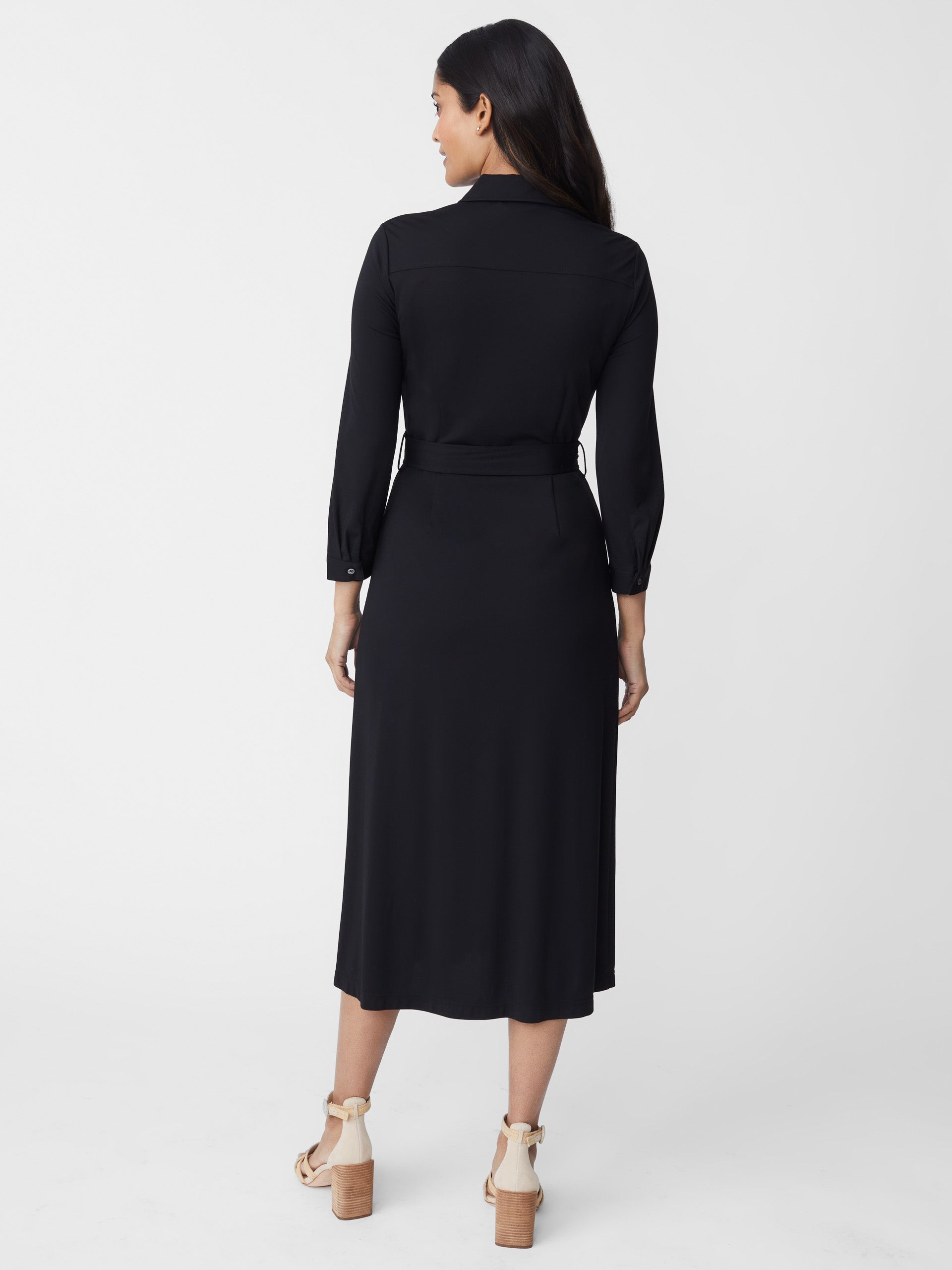 Model wearing J.McLaughlin Pamela dress in black made with raylon/nylon/spandex.