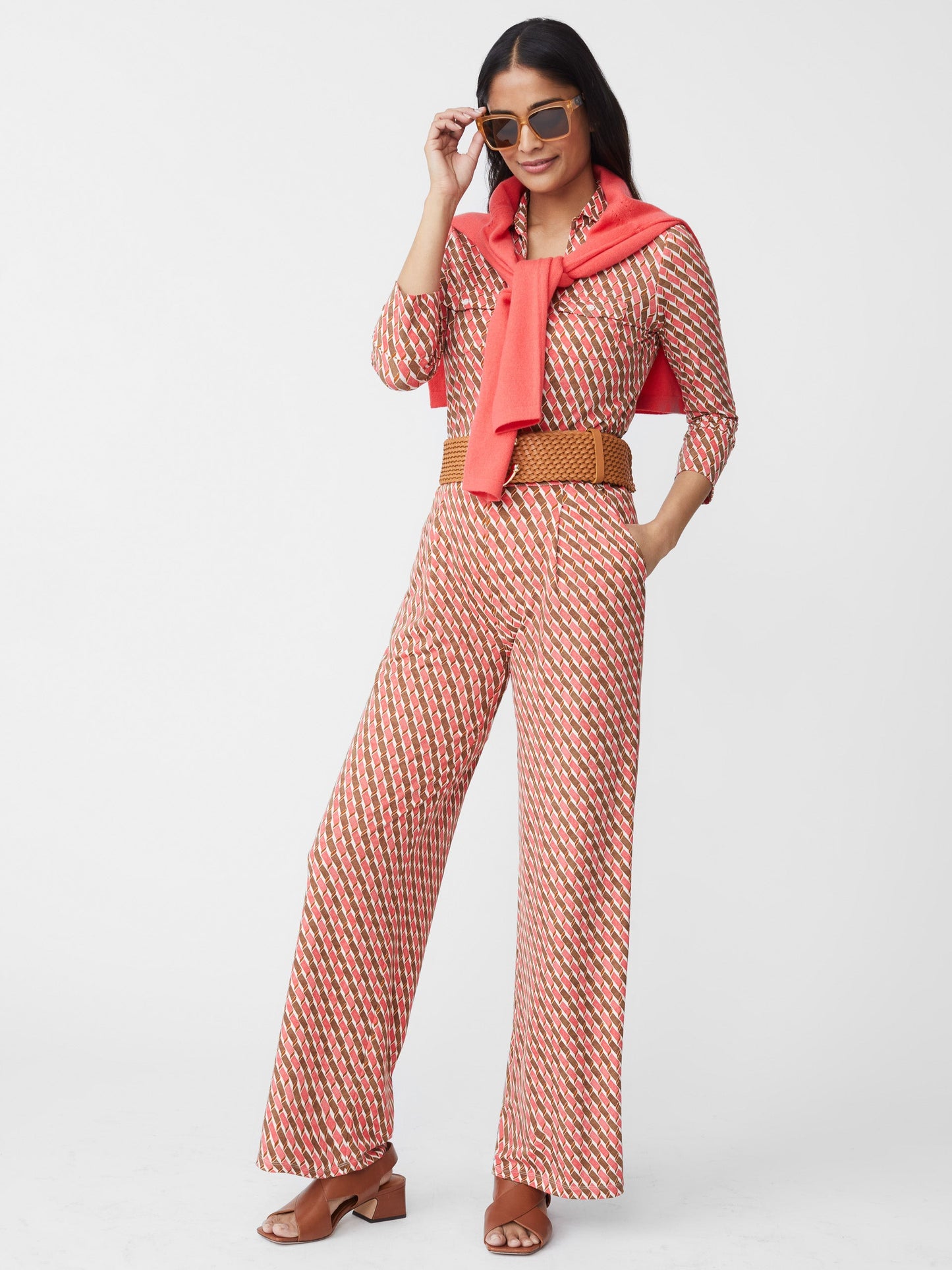 Model wears J.McLaughlin Pasha pants in coral/brown made with polyester/spandex.