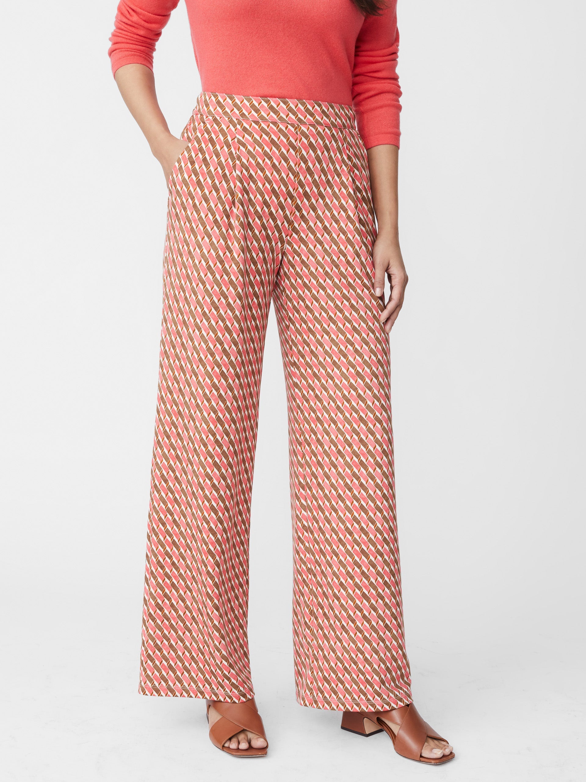 Model wears J.McLaughlin Pasha pants in coral/brown made with polyester/spandex.