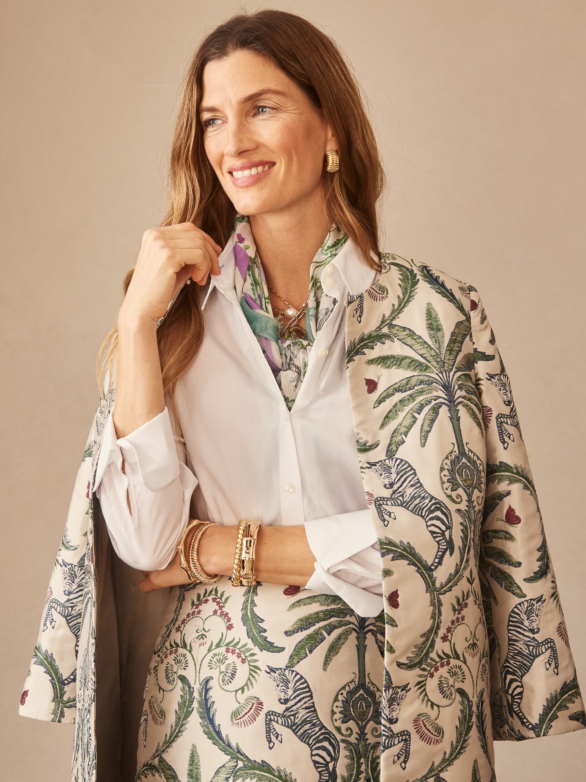 Woman wearing Judy Coat in Maxi Zebra Isle Jacquard by J.McLaughlin, featuring an elegant zebra and palm print over a white shirt, embodying effortlessly stylish, enduring designs with a legacy of timeless fashion. A destination for defining style. Life, Well-Lived.