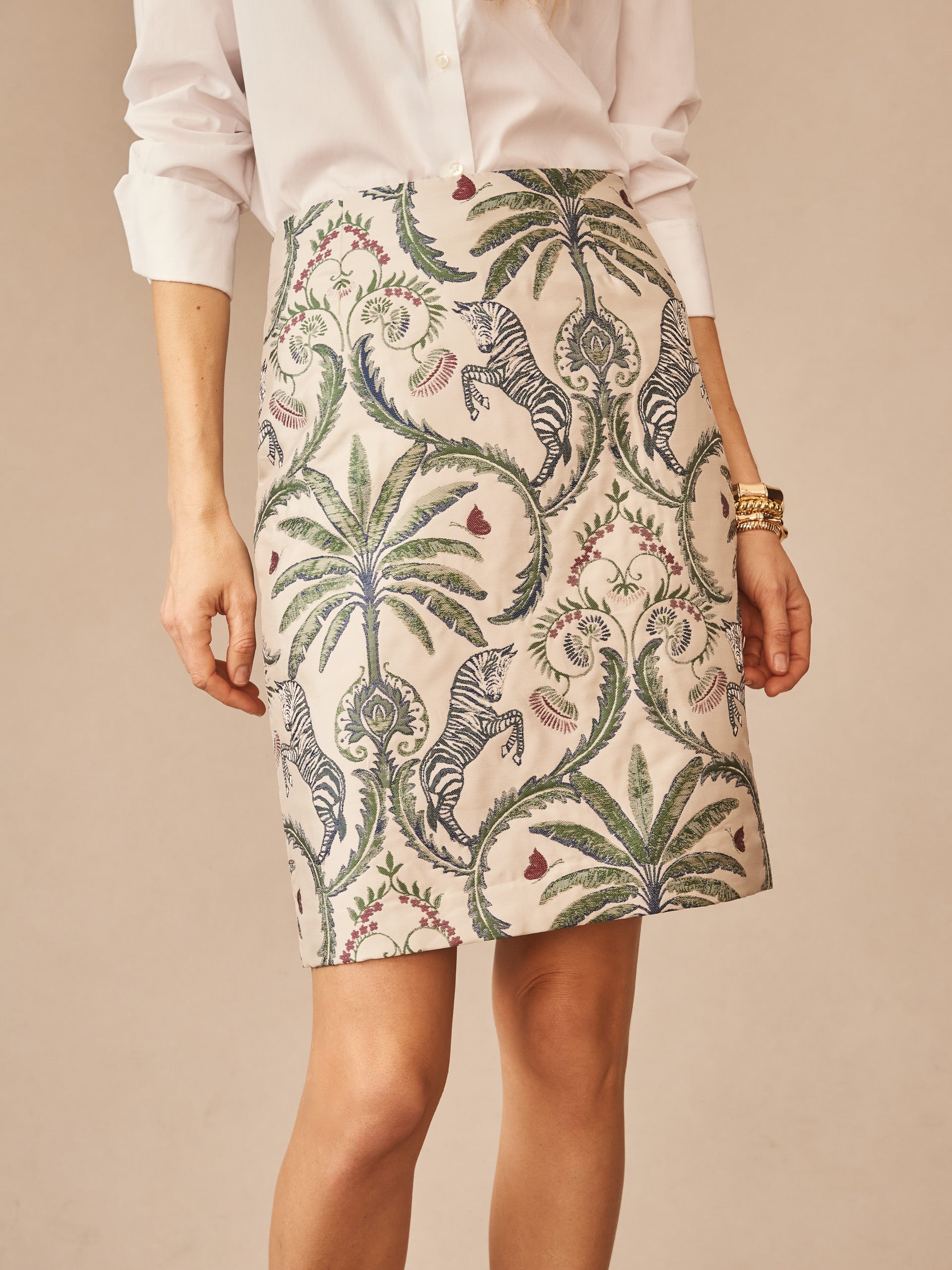 Woman wearing Patricia Skirt in Maxi Zebra Isle Jacquard by J.McLaughlin, featuring a nature-inspired pattern with zebras and palm leaves in a thoughtfully crafted, effortlessly stylish design.