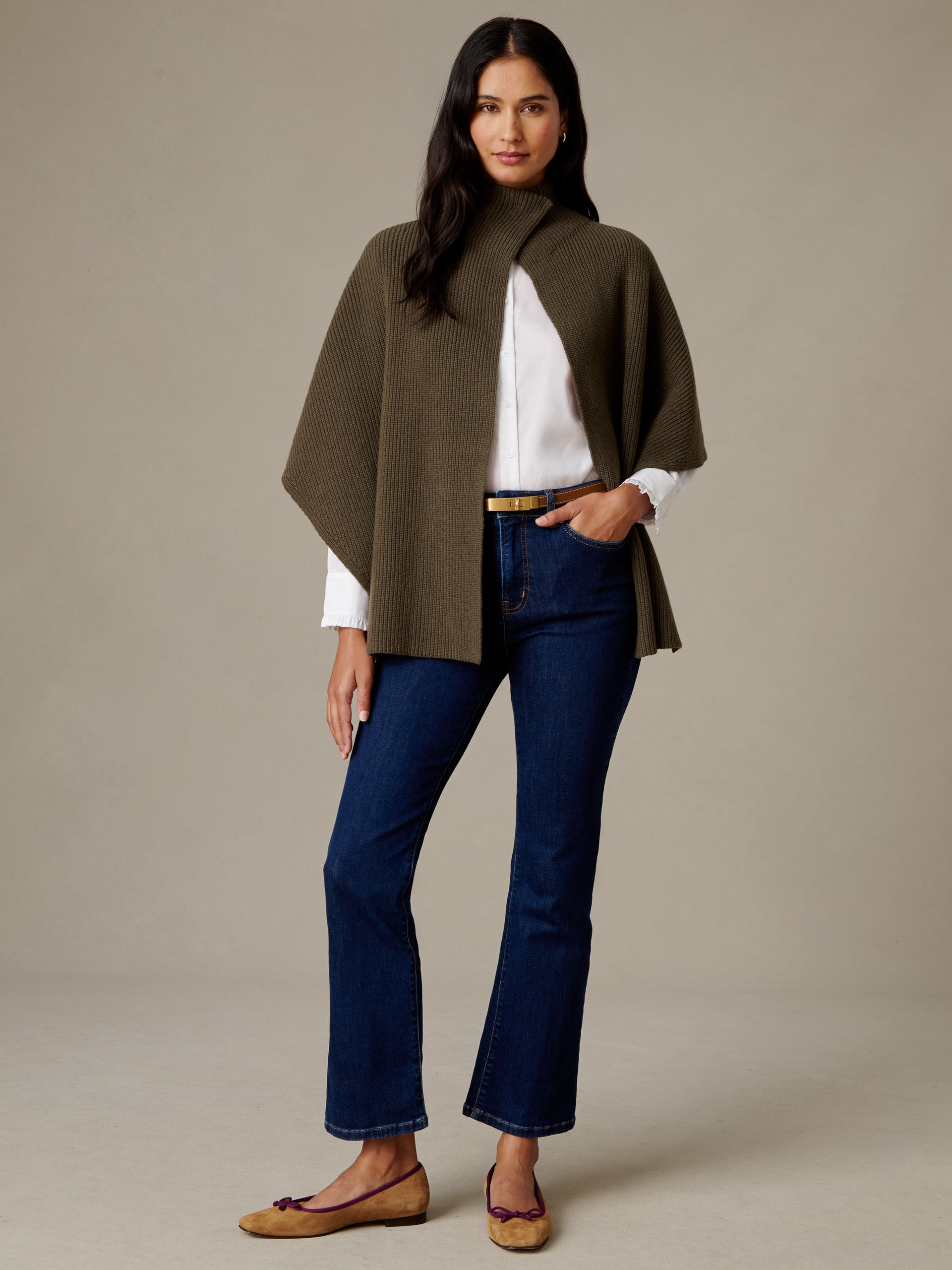 J.McLaughlin Philippa Cape in olive merino wool with a mock neck styled over a white top with dark jeans and flats on a model