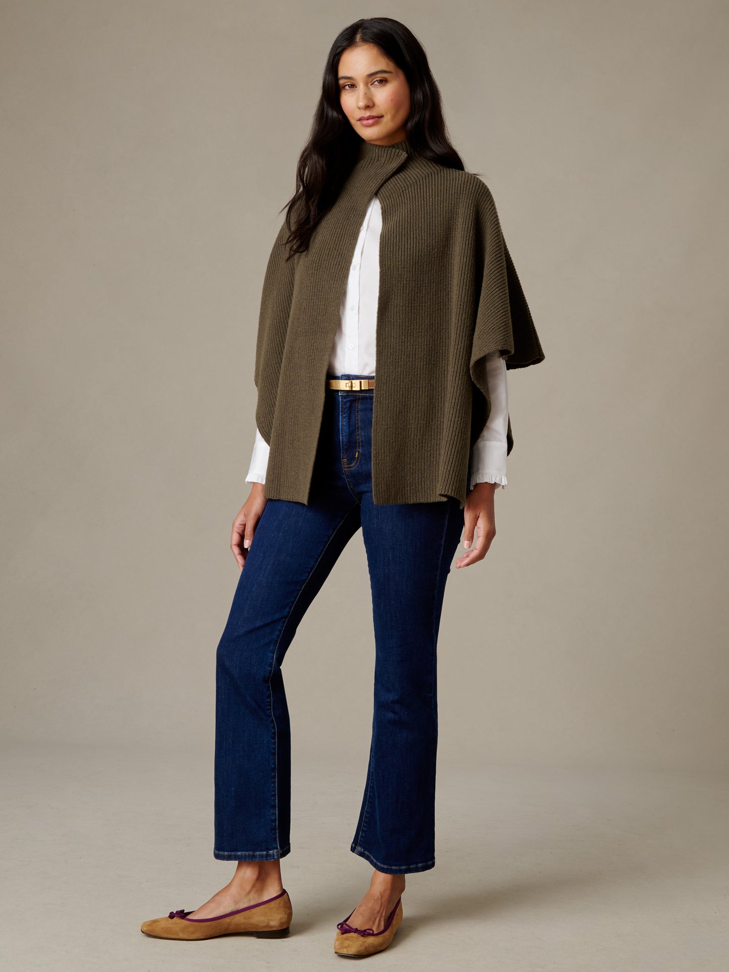 J.McLaughlin Philippa Cape in olive merino wool styled over a white top with dark jeans and leather sandals for an effortlessly timeless look