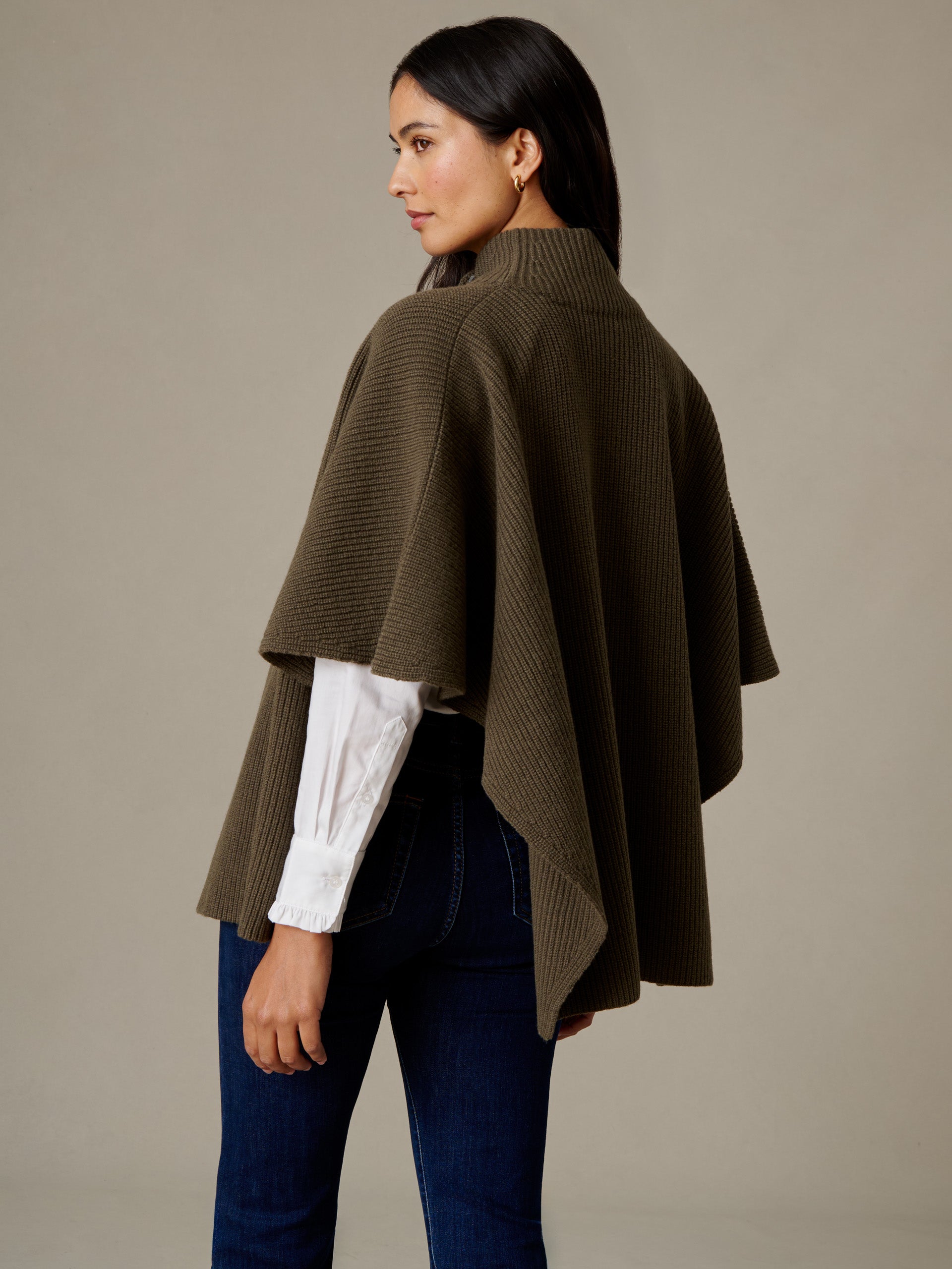 J.McLaughlin Philippa Cape in soft olive merino wool styled over a white blouse and dark jeans for an effortlessly stylish layered look