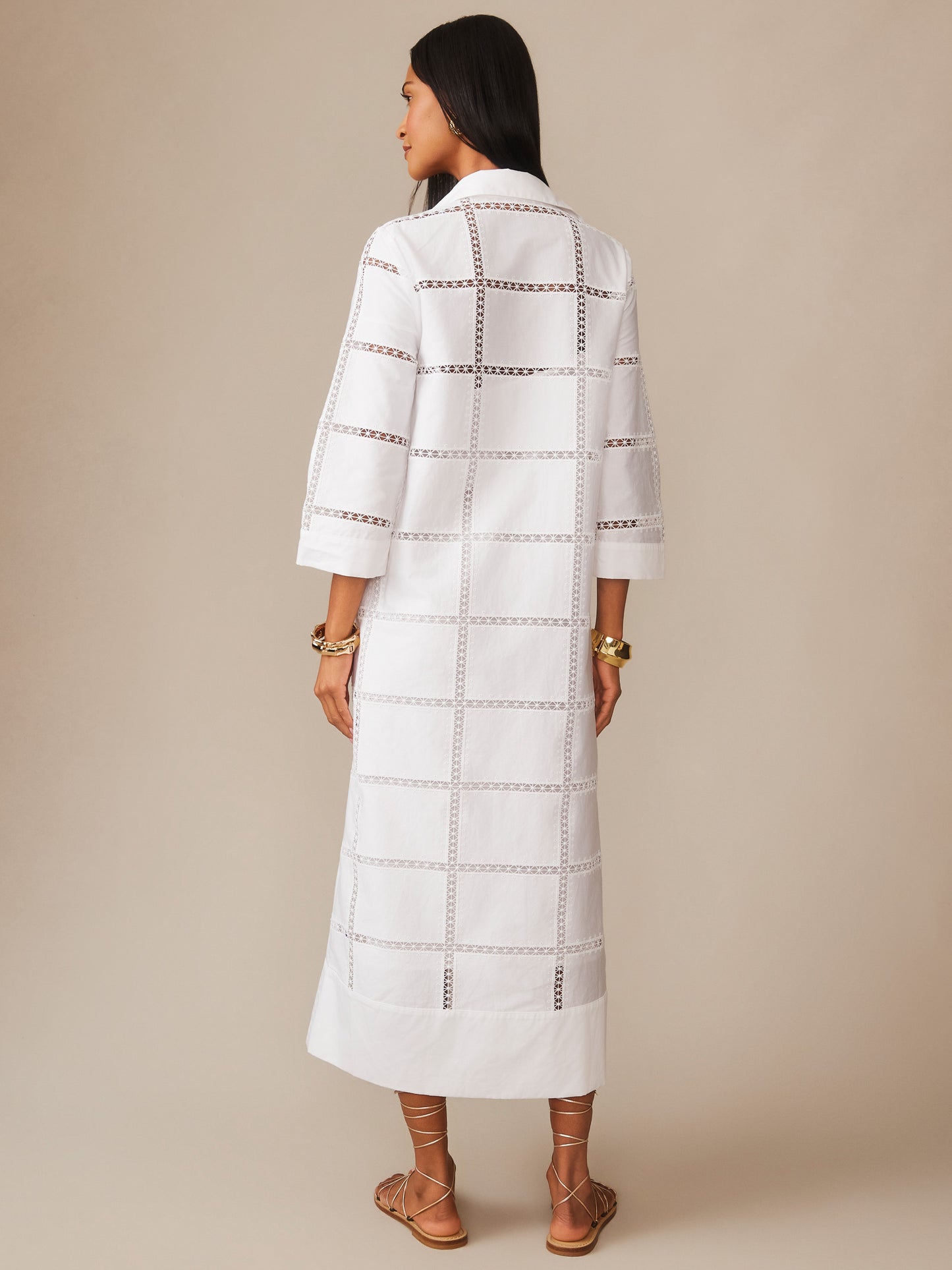Woman modeling the Rachel Embroidered Dress by J.McLaughlin in white, featuring a grid pattern with embroidered cutouts, 3/4 sleeves, and a relaxed fit, embodying effortlessly stylish, enduring designs for a life well-lived.