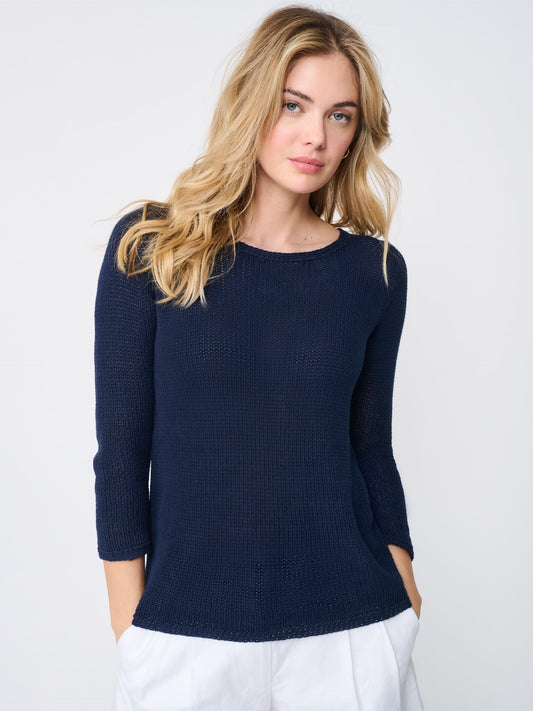 Model wearing J.McLaughlin Raelyn sweater in navy made with linen.