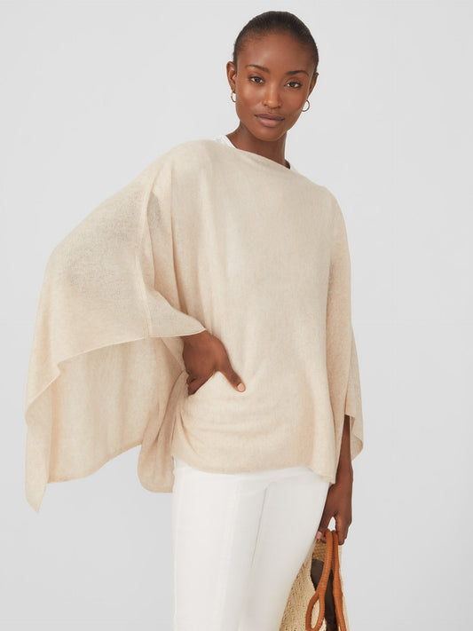 Model wearing J.McLaughlin Rale poncho in light heather oatmeal made with cashmere.