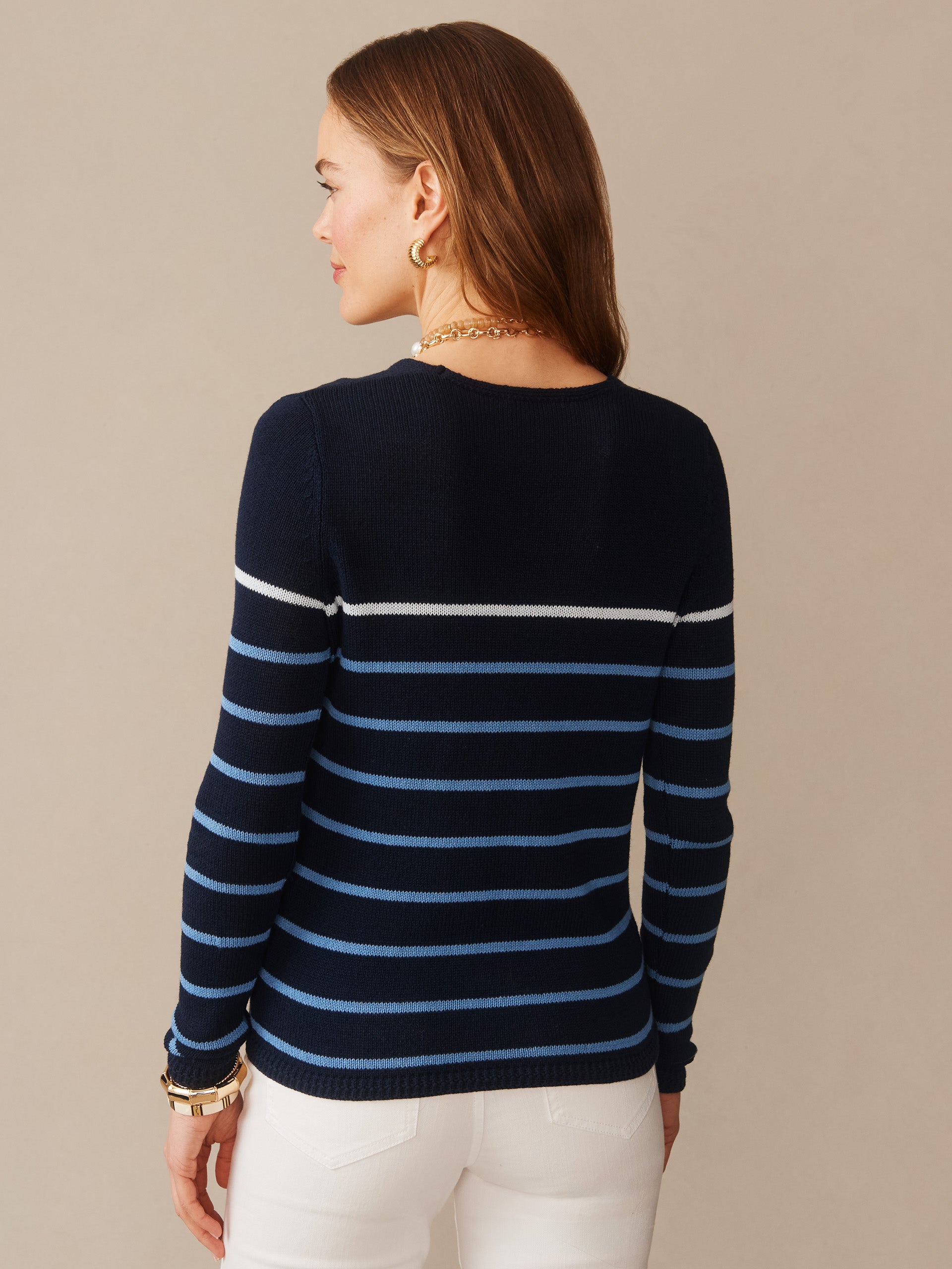 Woman wearing a navy and blue striped Ramona Linen Blend Sweater in Stripe by J.McLaughlin, showcasing effortlessly stylish, enduring designs with innovative fabrics and a legacy of timeless fashion. A destination for defining style. Life, Well-Lived.