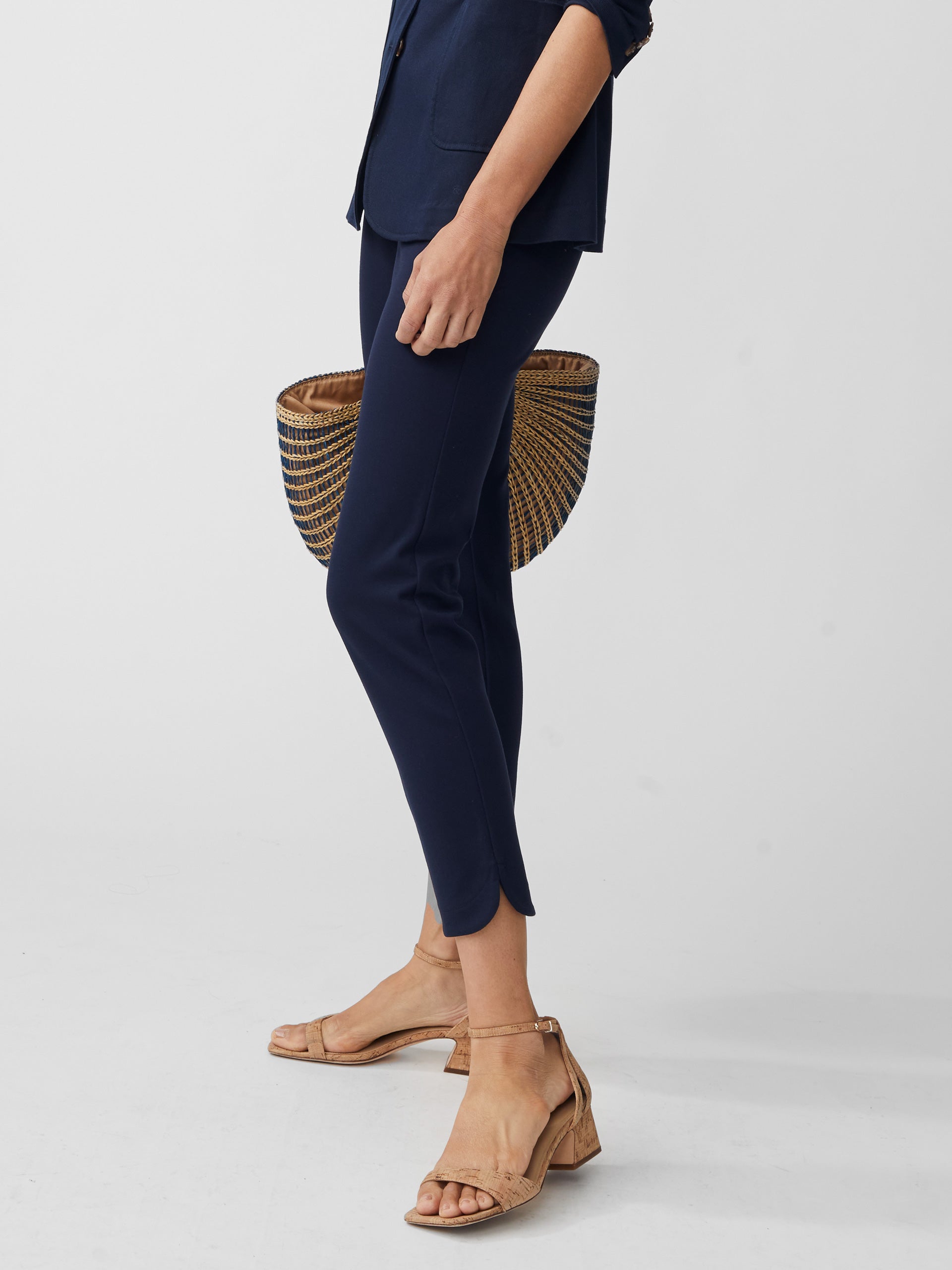 Model wearing J.McLaughlin Romilly pants in winter navy made with bainbridge fabric.