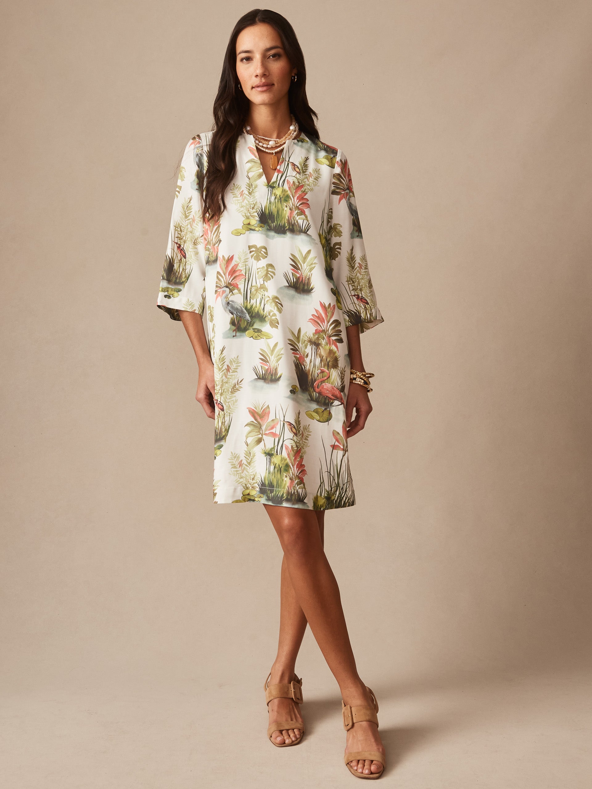 Woman wearing a Roni Dress in Tidal Palms by J.McLaughlin, featuring a classic white base with coral and green tropical prints, embodying effortlessly stylish, enduring designs and innovative fabrics. A destination for defining style. Life, Well-Lived.