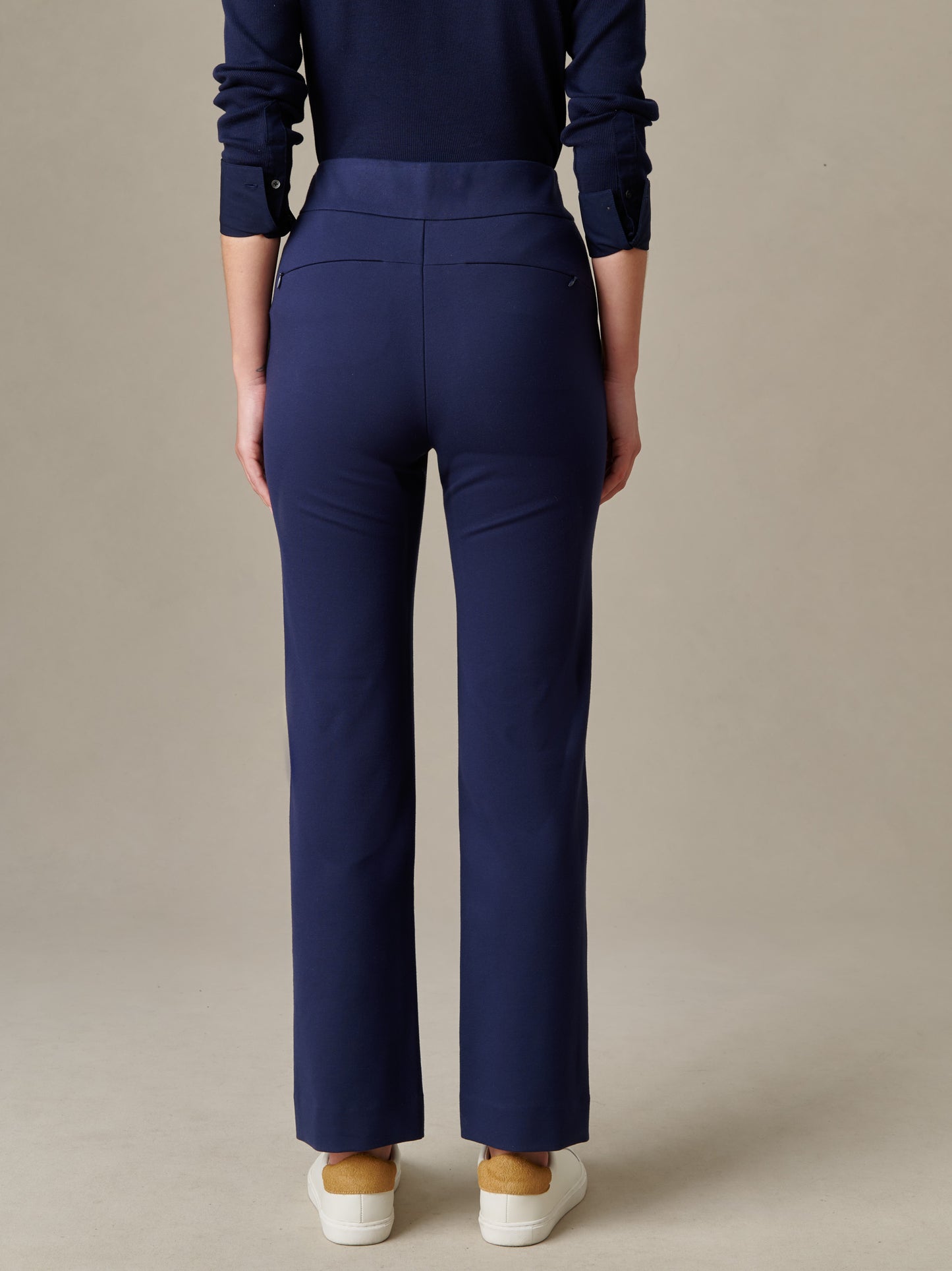 Rear view of a person wearing navy blue Rory Pants by J.McLaughlin, showcasing a tailored fit and clean lines that blend timeless craftsmanship with enduring style.