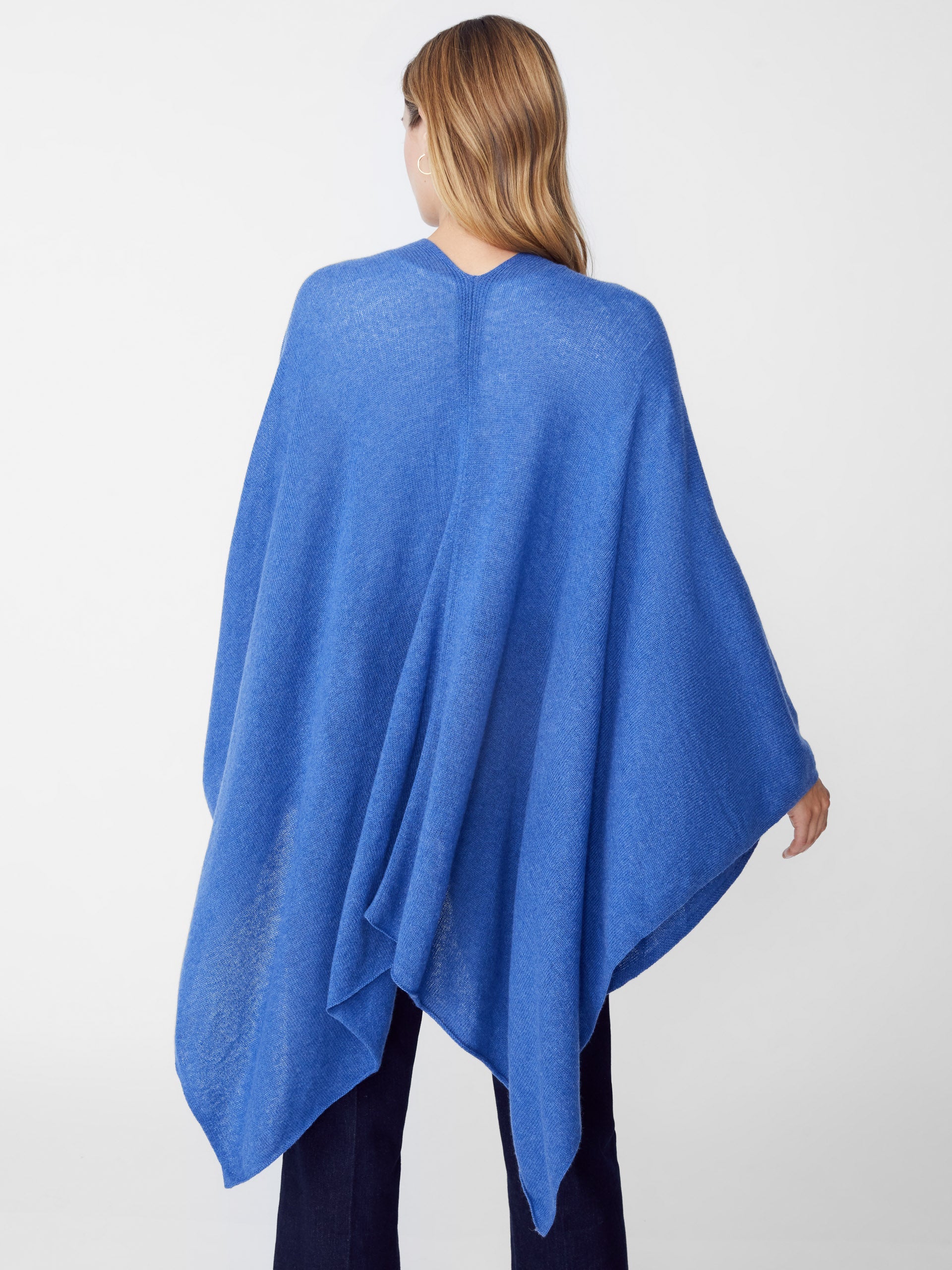 Model wearing J.McLaughlin Rossi wrap in blue made with cashmere.