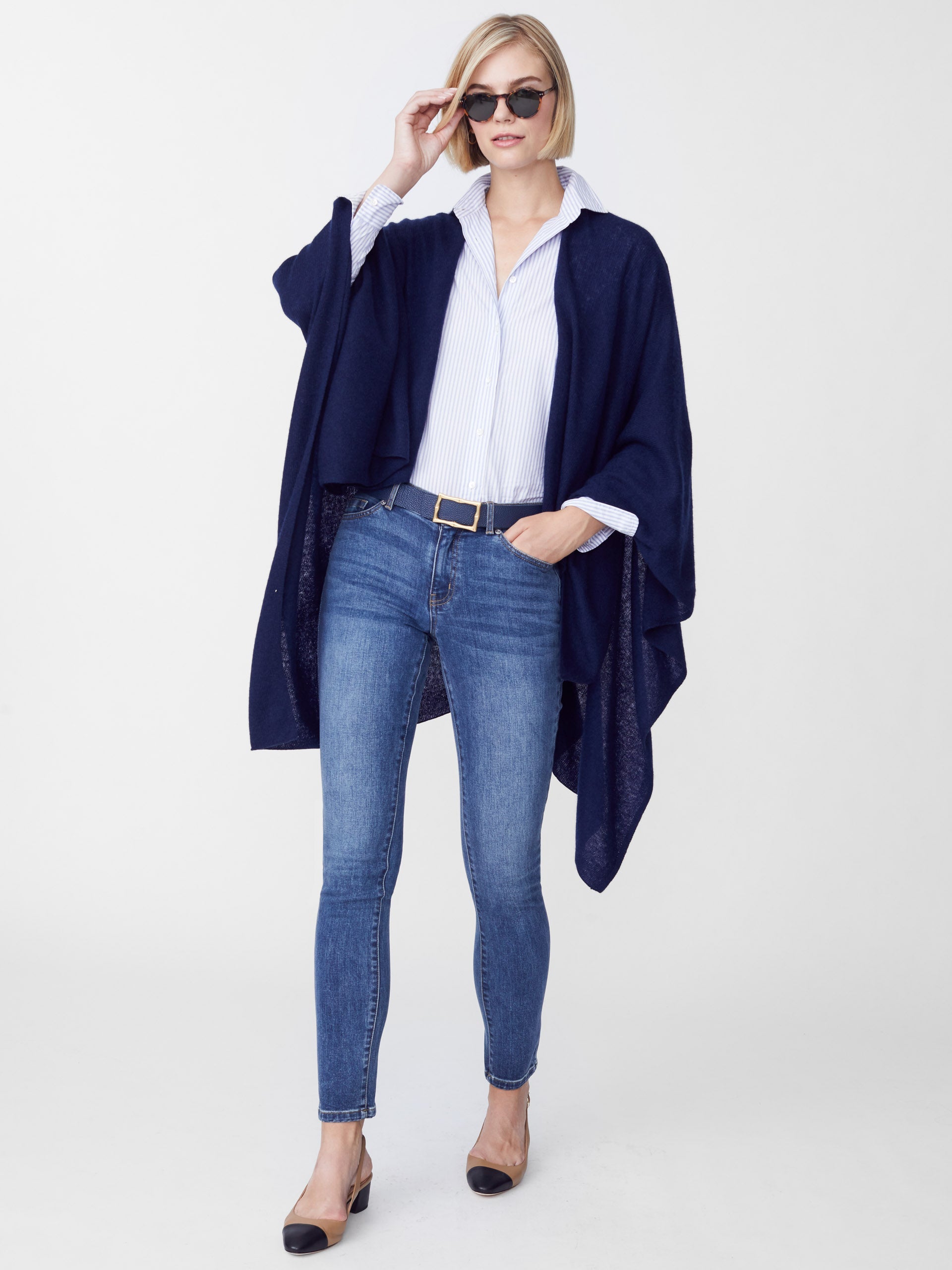 Model wearing J.McLaughlin Rossi wrap in navy made with cashmere.