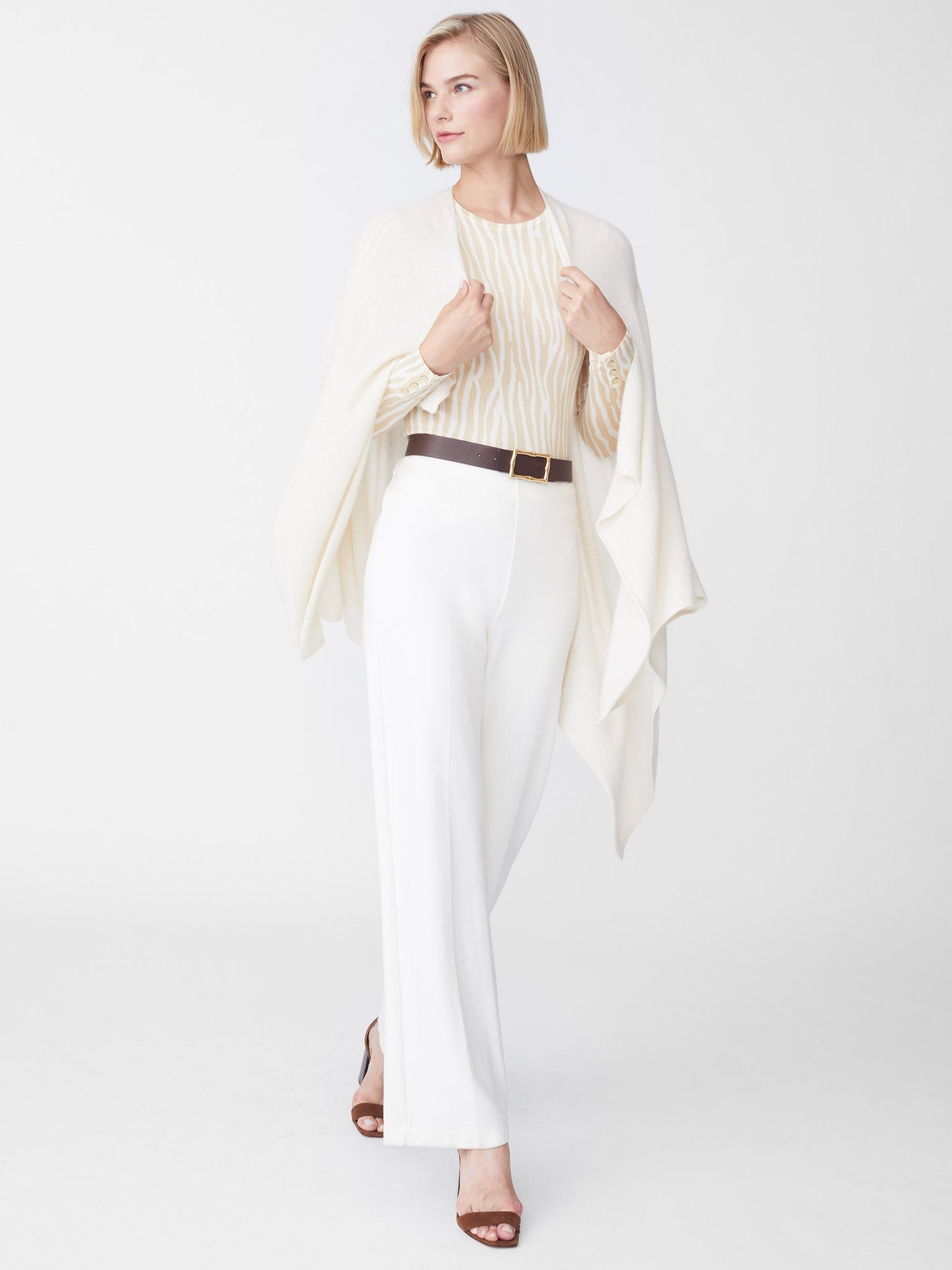 Model wearing J.McLaughlin Rossi wrap in off white made with cashmere.