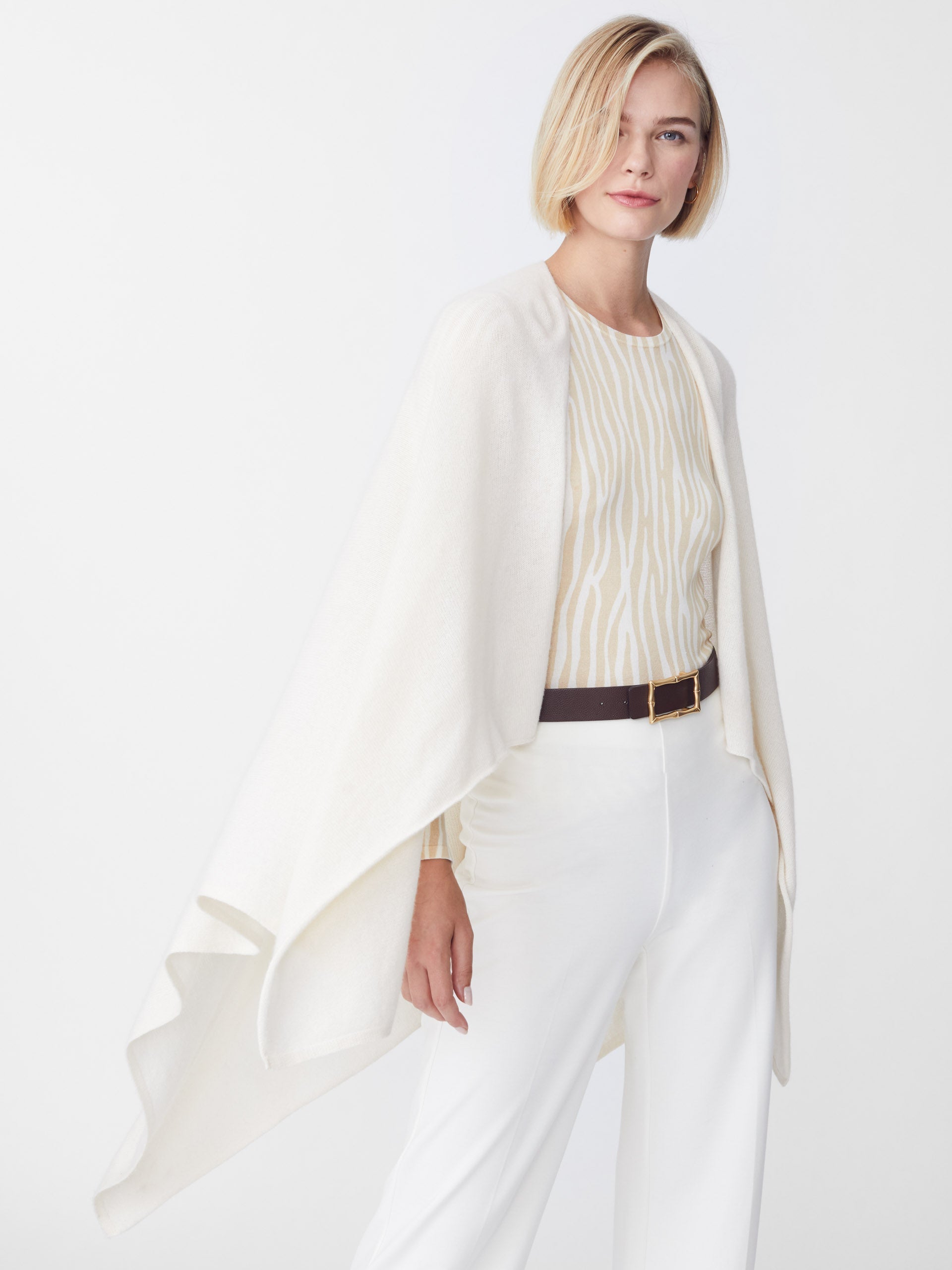 Model wearing J.McLaughlin Rossi wrap in off white made with cashmere.