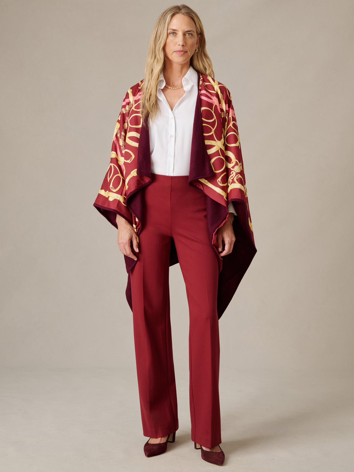 J.McLaughlin Rossi Cashmere Wrap in Grand Heraldic Border styled over a white blouse and burgundy trousers with an elegant draped silhouette