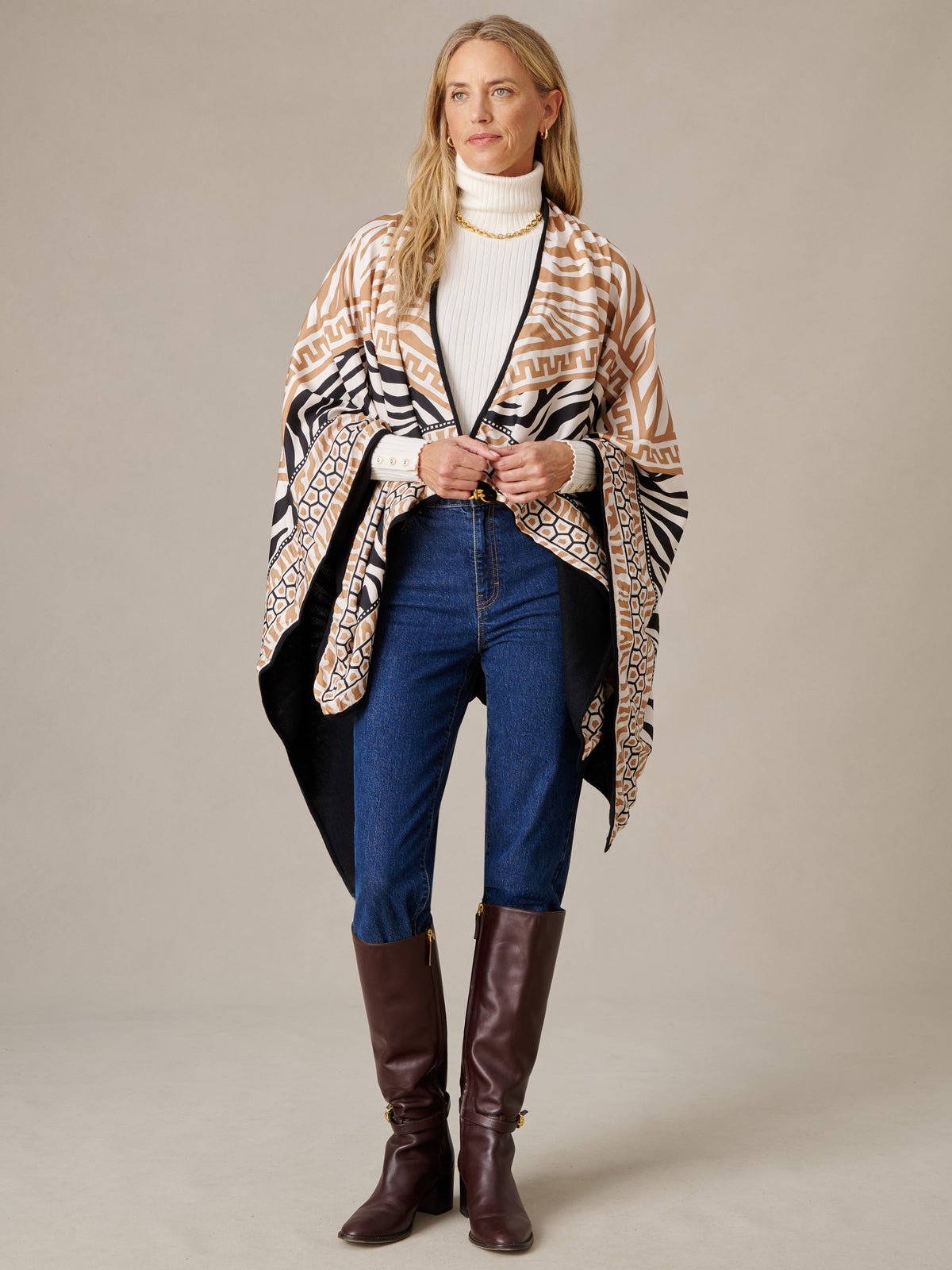 Rossi Cashmere Wrap in Wild Medley Border by J.McLaughlin shown on a model with a patterned drape layered over a white turtleneck and jeans