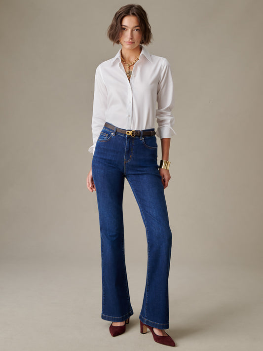 Woman wearing Domino Jeans by J.McLaughlin paired with a white blouse, styled with a belt and gold jewelry, showcasing timeless and effortlessly stylish classic denim.