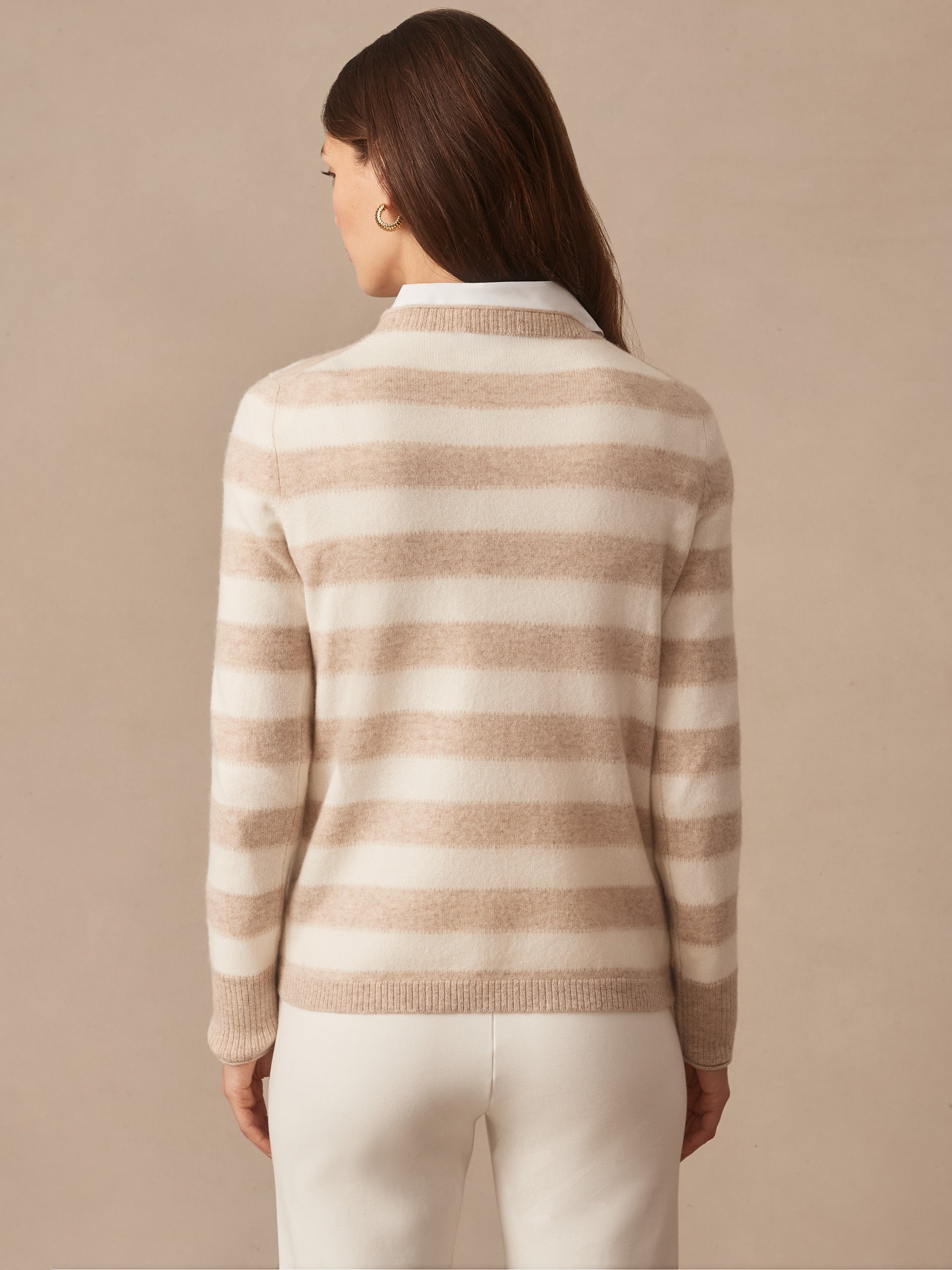 Woman wearing a Ruby Cashmere Sweater in Stripe by J.McLaughlin, featuring soft beige and ivory stripes, perfectly blending effortlessly stylish, enduring designs with a legacy of timeless fashion. A destination for defining style. Life, Well-Lived.