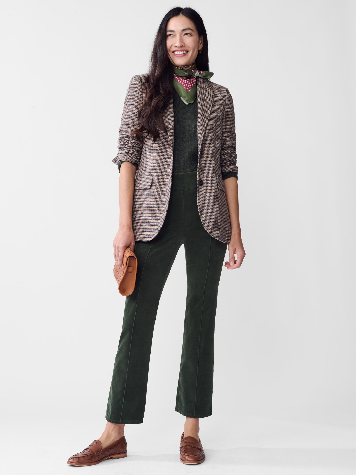 Model wearing J.McLaughlin Rylie pants in dark forest made with velveteen.