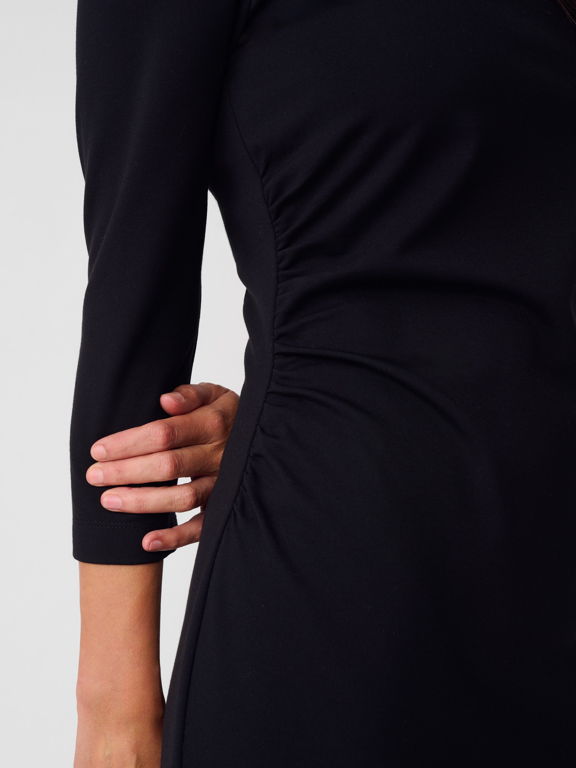 Model wearing J.McLaughlin Sarra dress in black made with refined bainbridge fabric.