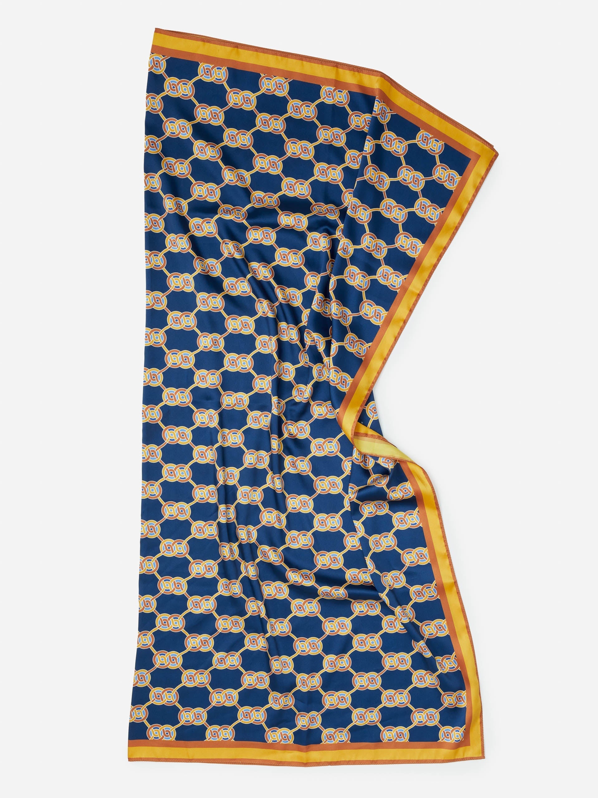 Gemma Scarf in Heraldic Knot by J.McLaughlin features an effortlessly stylish navy and gold pattern with enduring designs in innovative fabrics, embodying a legacy of timeless fashion. A destination for defining style. Life, Well-Lived.
