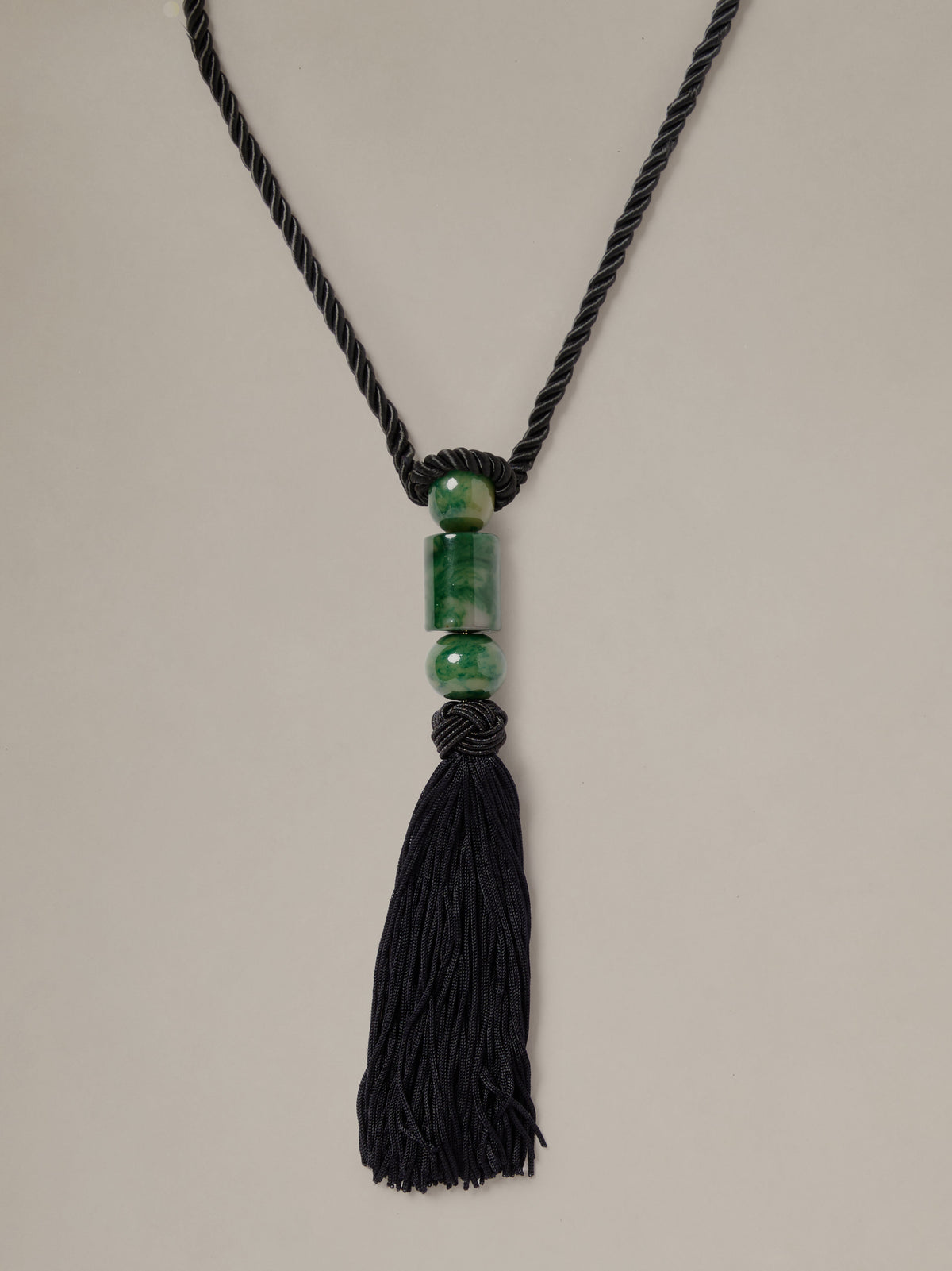 J.McLaughlin Tassel Necklace with a black braided cord green beads and a long black tassel for effortlessly stylish timeless appeal