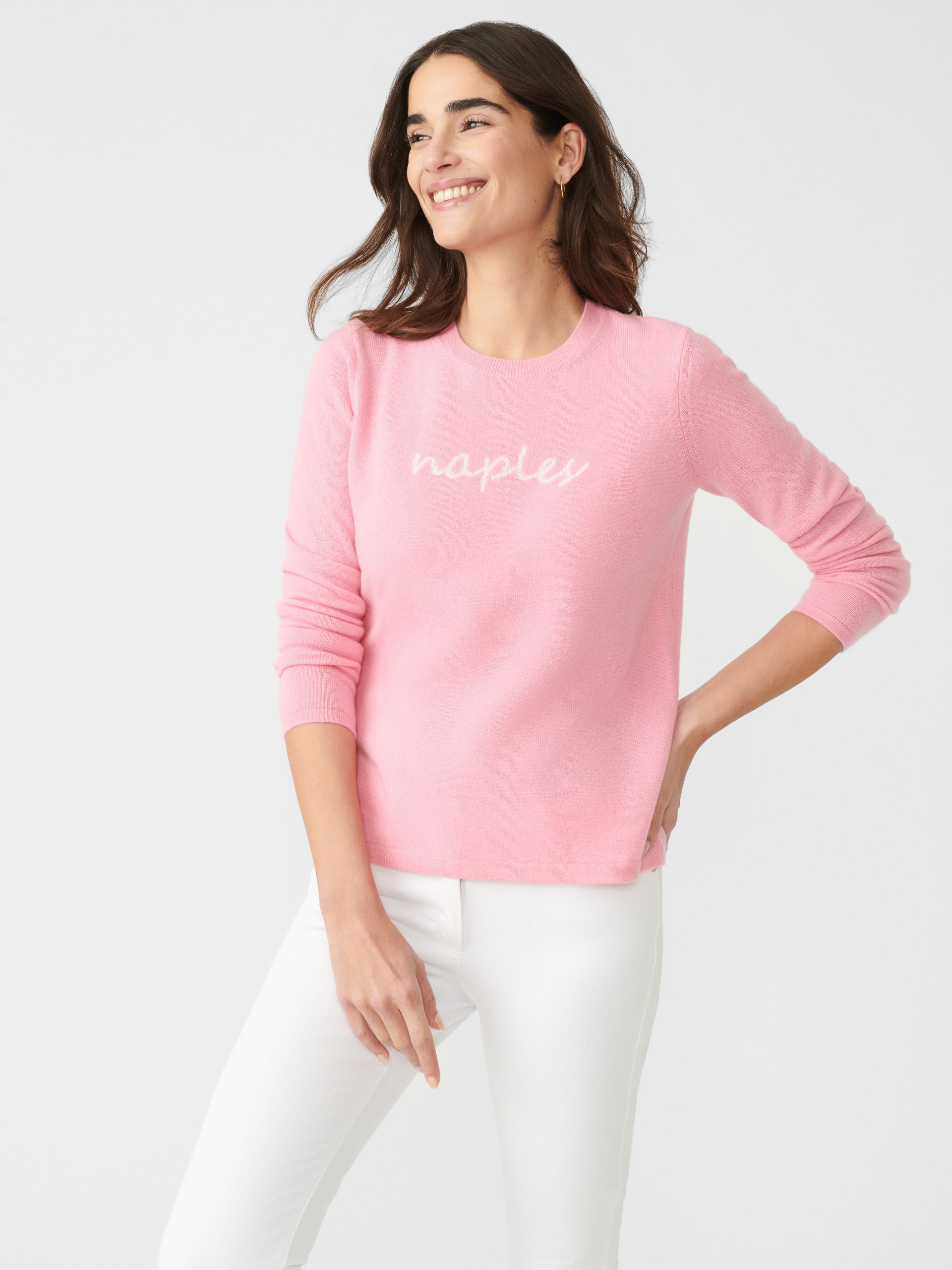 Model wearing J.McLaughlin Shield sweater in pink/white made with cashmere.