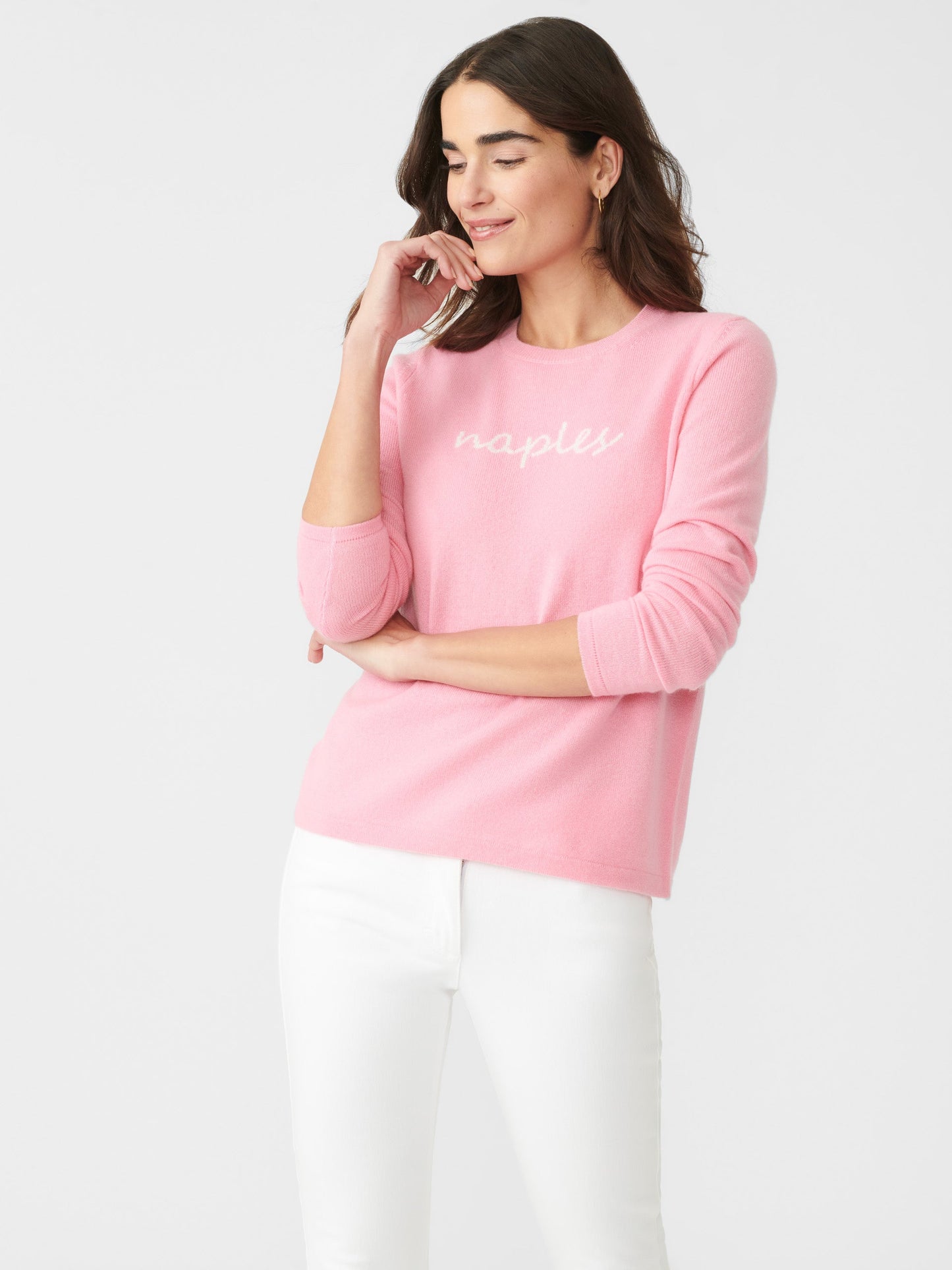 Model wearing J.McLaughlin Shield sweater in pink/white made with cashmere.