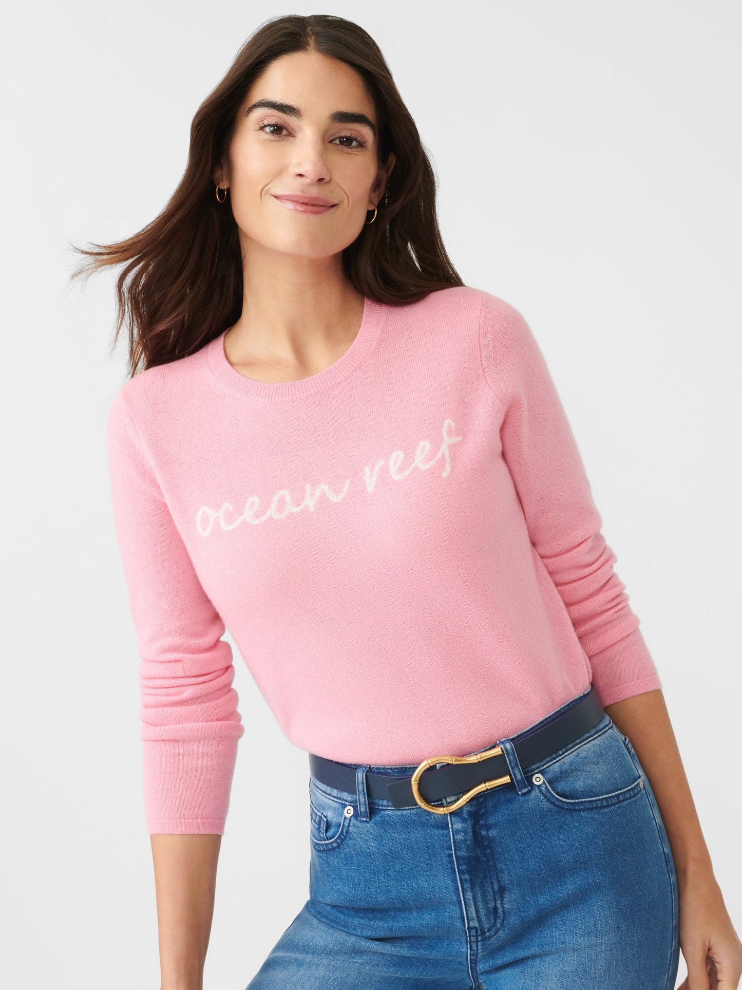 Model wearing J.McLaughlin Shield sweater in pink/white made with cashmere.