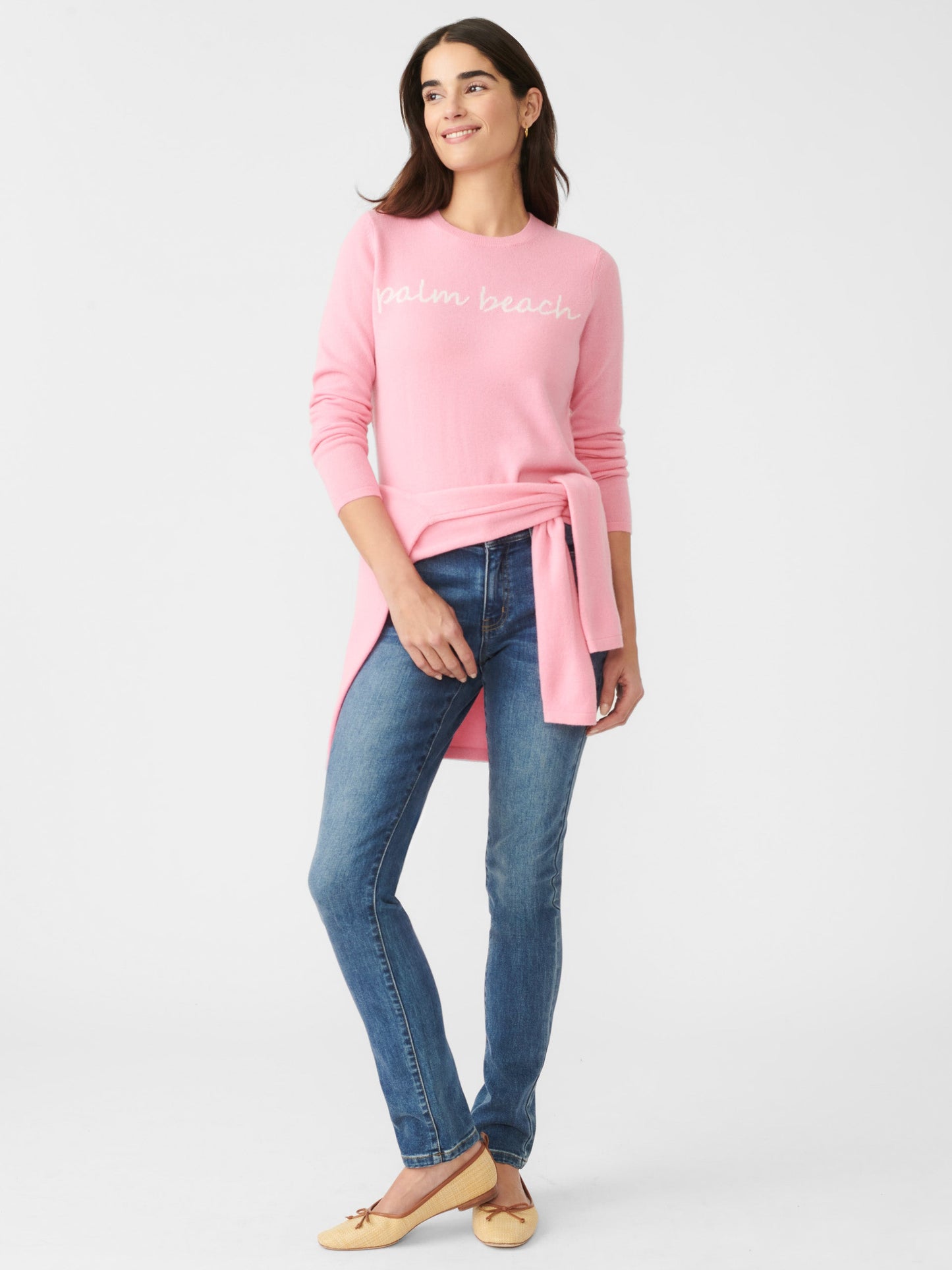 Model wearing J.McLaughlin Shield sweater in pink/white made with cashmere.