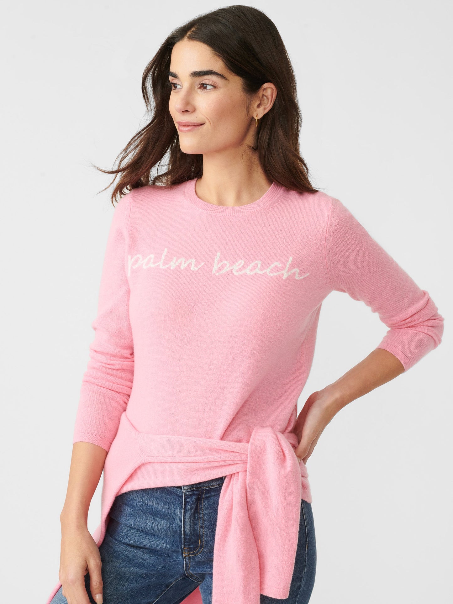 Model wearing J.McLaughlin Shield sweater in pink/white made with cashmere.