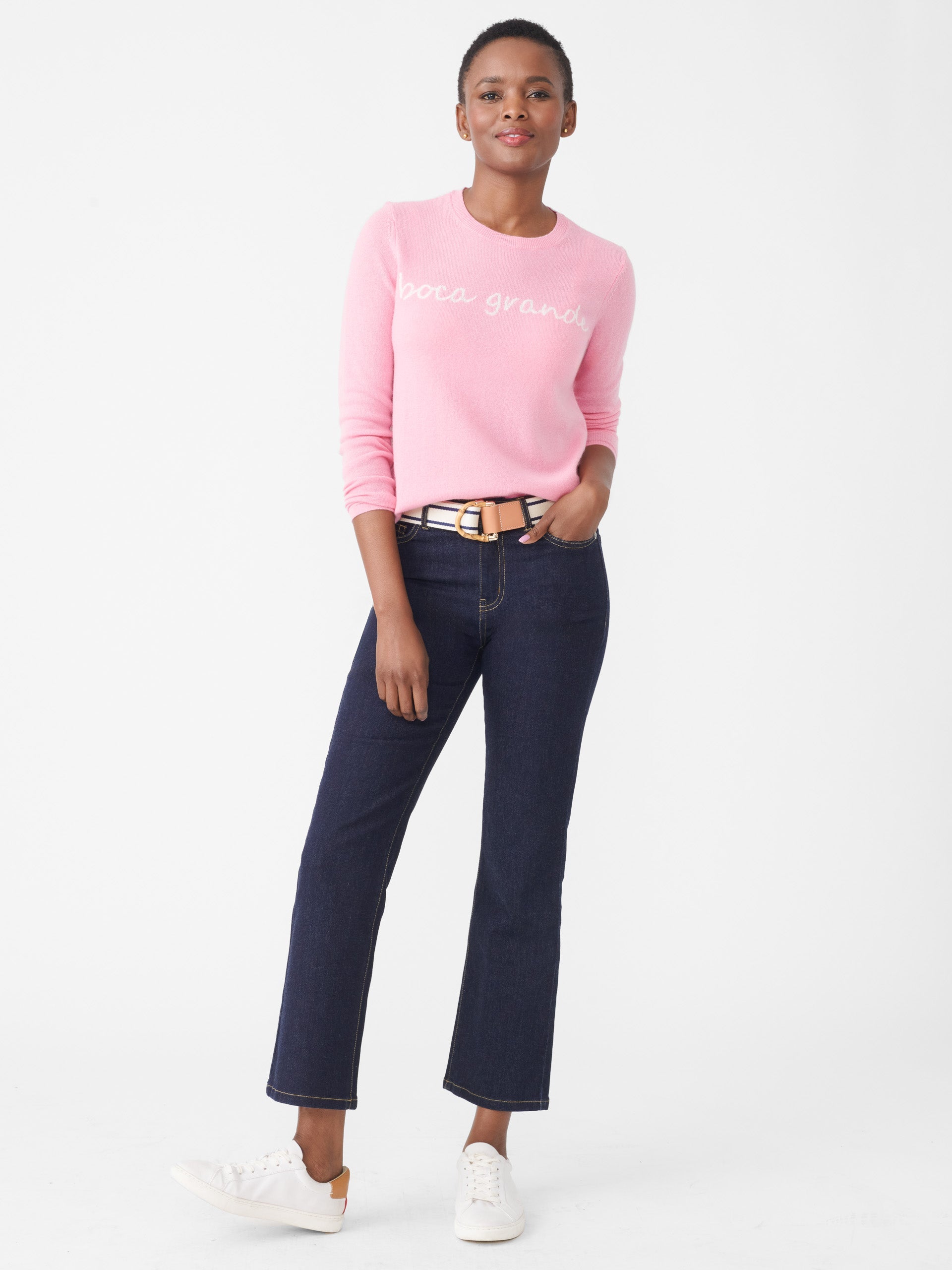 Model wearing J.McLaughlin Shield sweater in pink/white made with cashmere.