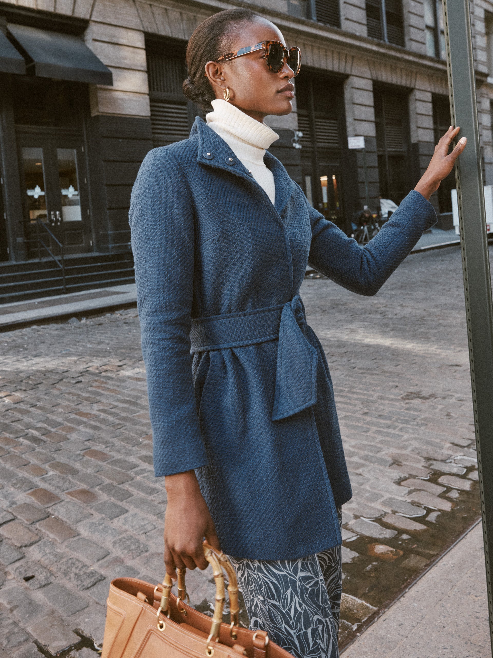 Model wears J.McLaughlin Arden Tweed Coat in navy made with cotton.