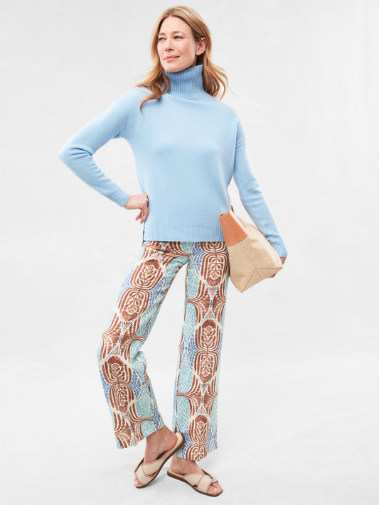 Model wears J.McLaughlin Carter pants in brown/aqua made with lyocell/linen.