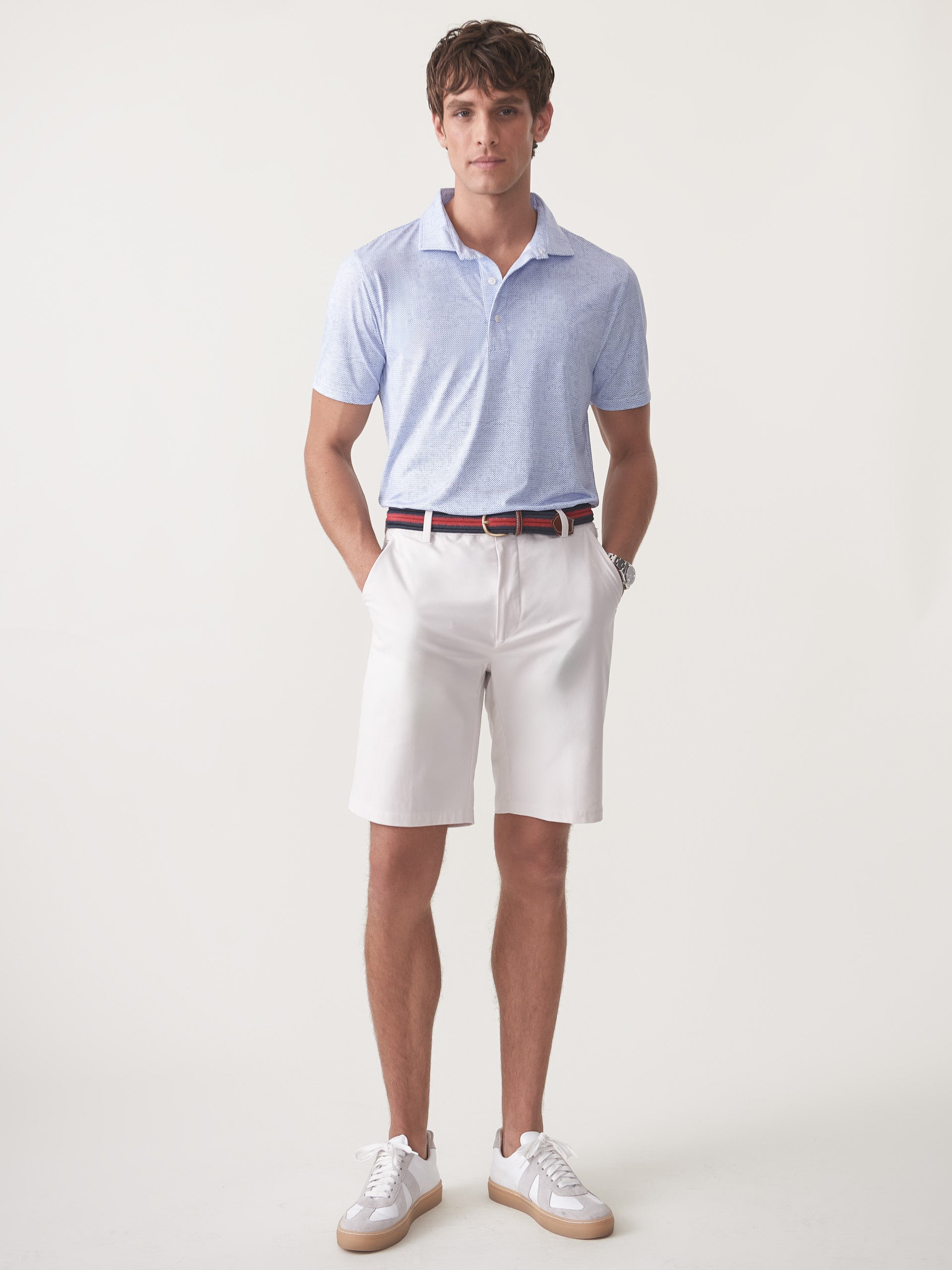 Model wearing J.McLaughlin Silas shorts in stone made with performance fabric.