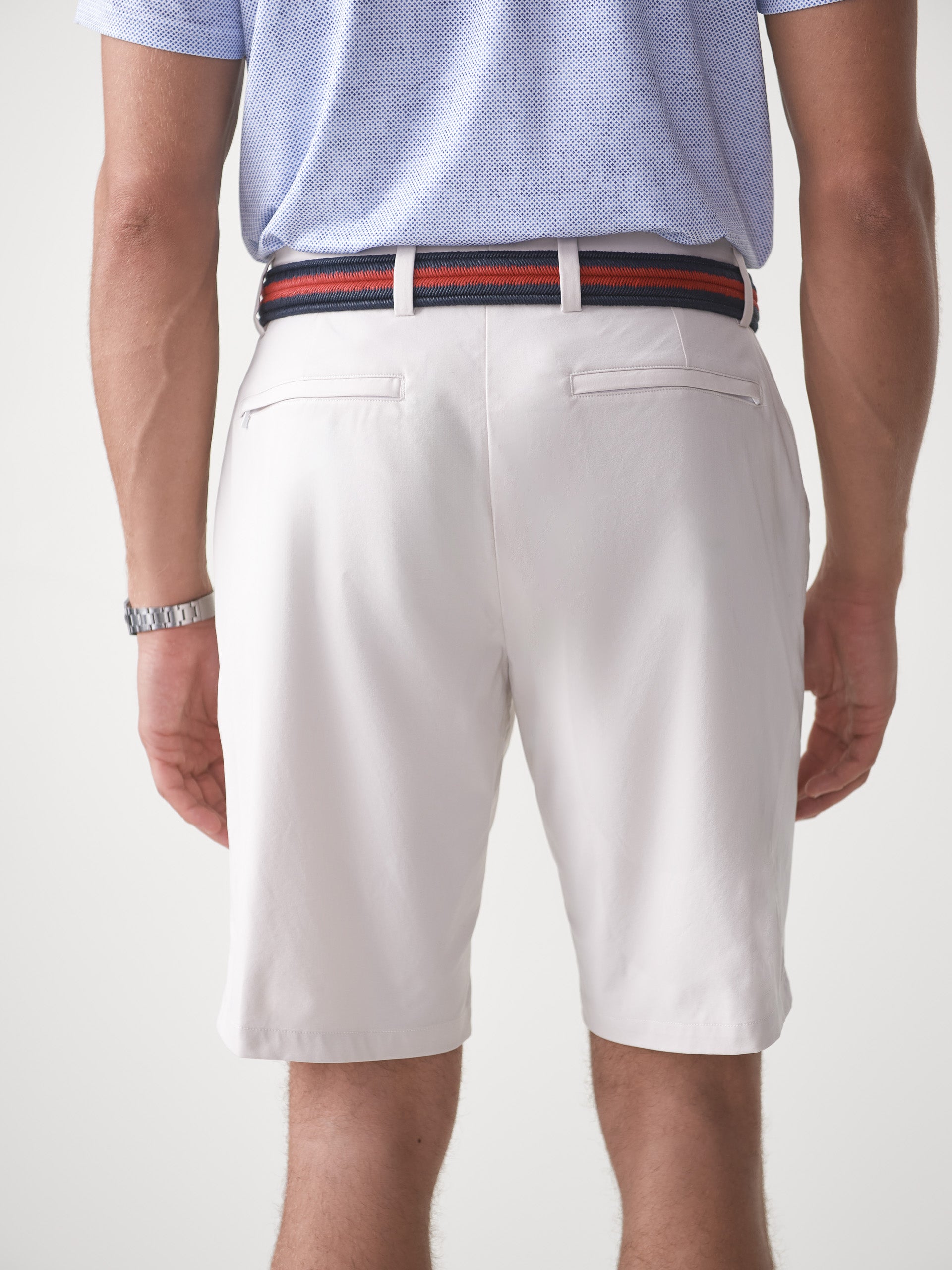 Model wearing J.McLaughlin Silas shorts in stone made with performance fabric.