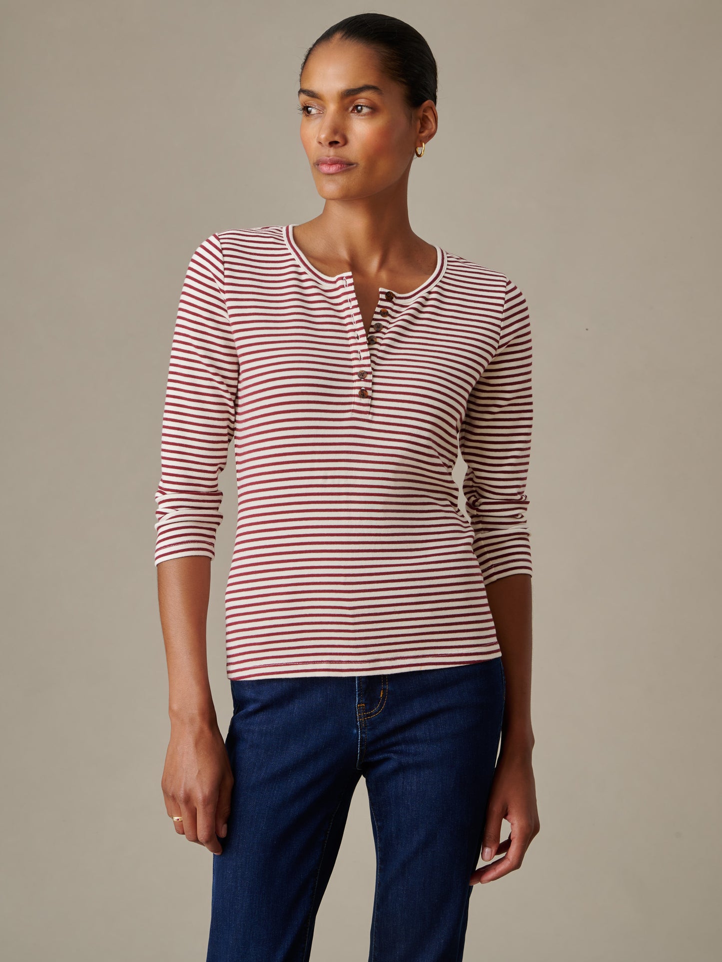 Woman wearing a Sinclair Henley in Stripe, a stylish lightweight striped top by J.McLaughlin, showcasing timeless design and impeccable craftsmanship.