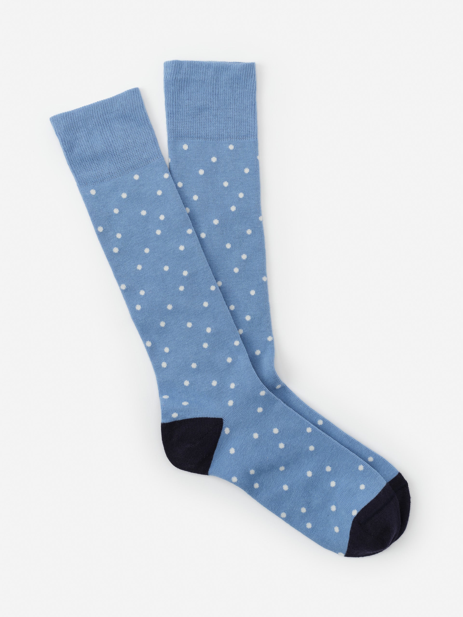 Socks in Polka Dots by J.McLaughlin in blue with white polka dots and dark blue toes, showcasing effortlessly stylish, enduring designs and innovative fabrics for a legacy of timeless fashion. A destination for defining style. Life, Well-Lived.
