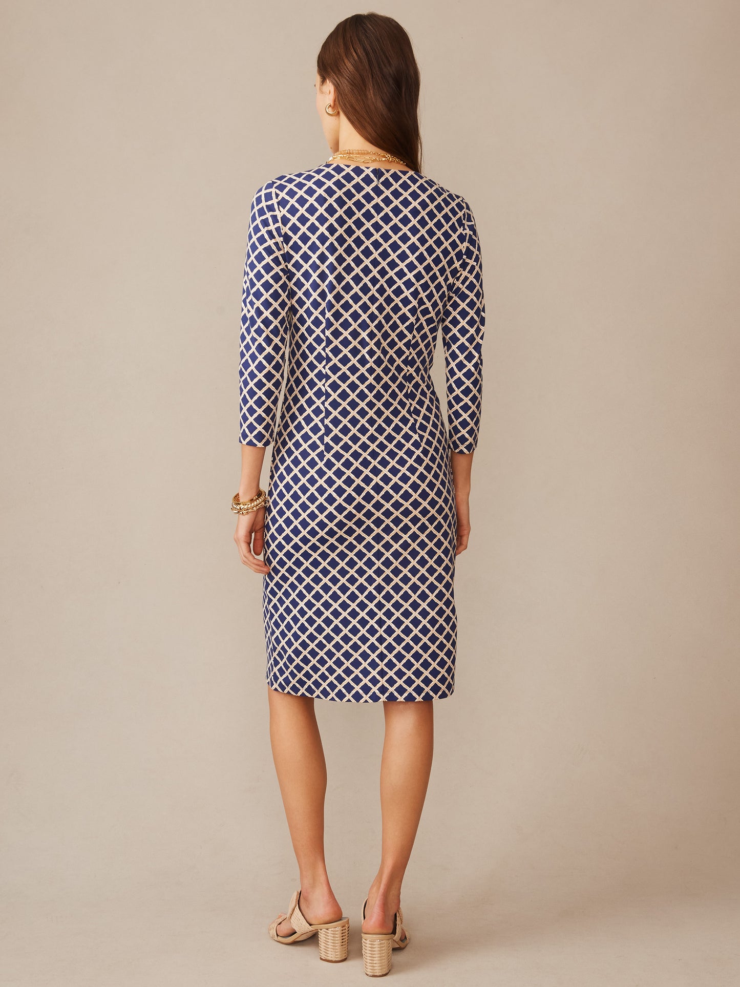 Woman wearing a navy and sand diamond-patterned Sophia Dress in Micro Bamboo by J.McLaughlin, showcasing effortlessly stylish, enduring designs with a modern, timeless look.