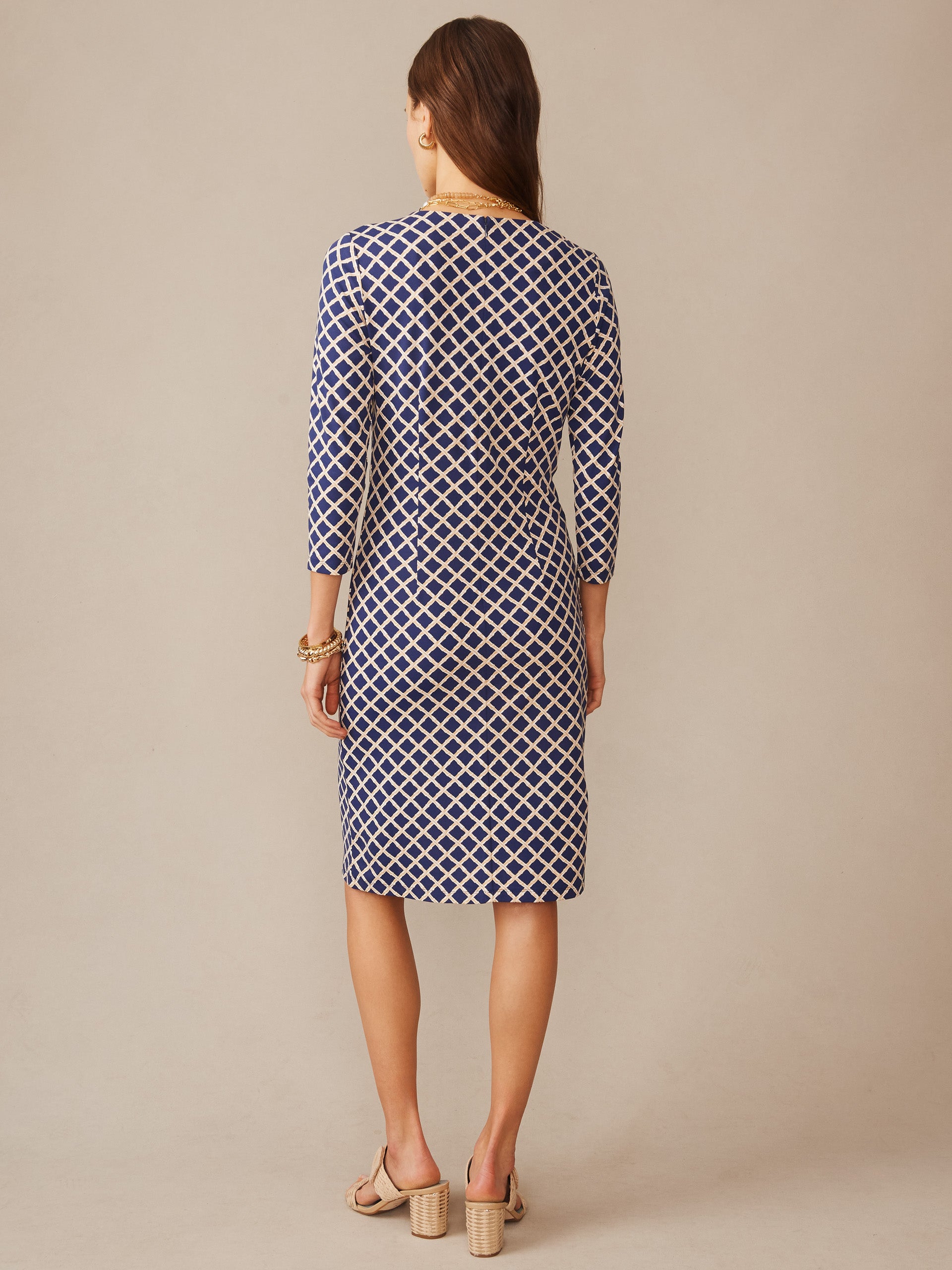 Woman wearing a navy and sand diamond-patterned Sophia Dress in Micro Bamboo by J.McLaughlin, showcasing effortlessly stylish, enduring designs with a modern, timeless look.