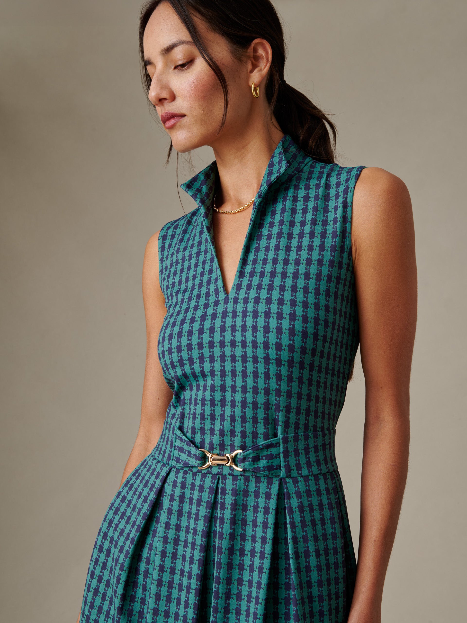 Woman wearing Steffi Dress in Algiers Check by J.McLaughlin, showcasing timeless style with a sleeveless collar design and a belted waist in a classic check pattern.
