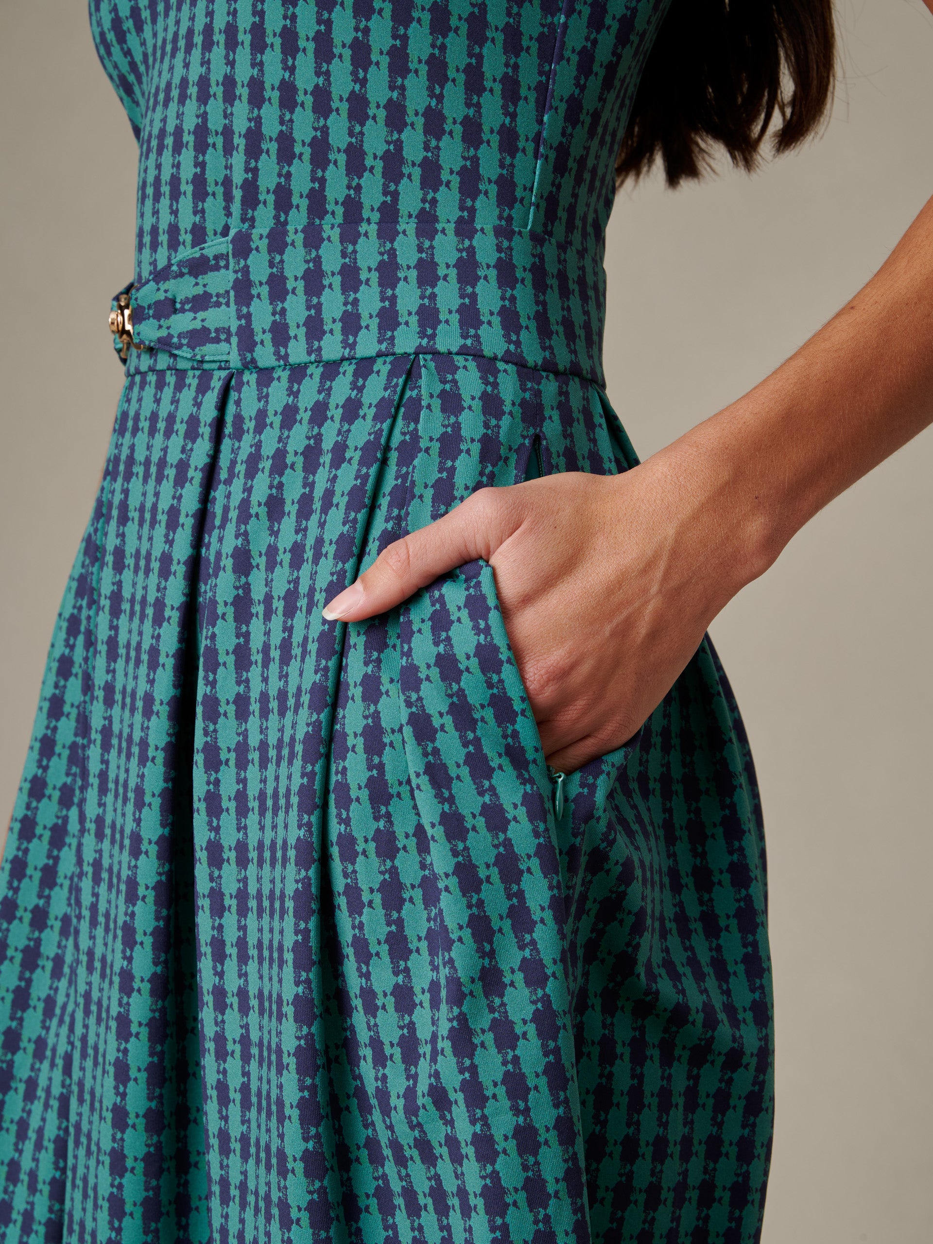 Close-up of a hand in the pocket of the Steffi Dress in Algiers Check by J.McLaughlin, showcasing its elegant pattern and craftsmanship in an effortlessly stylish design.